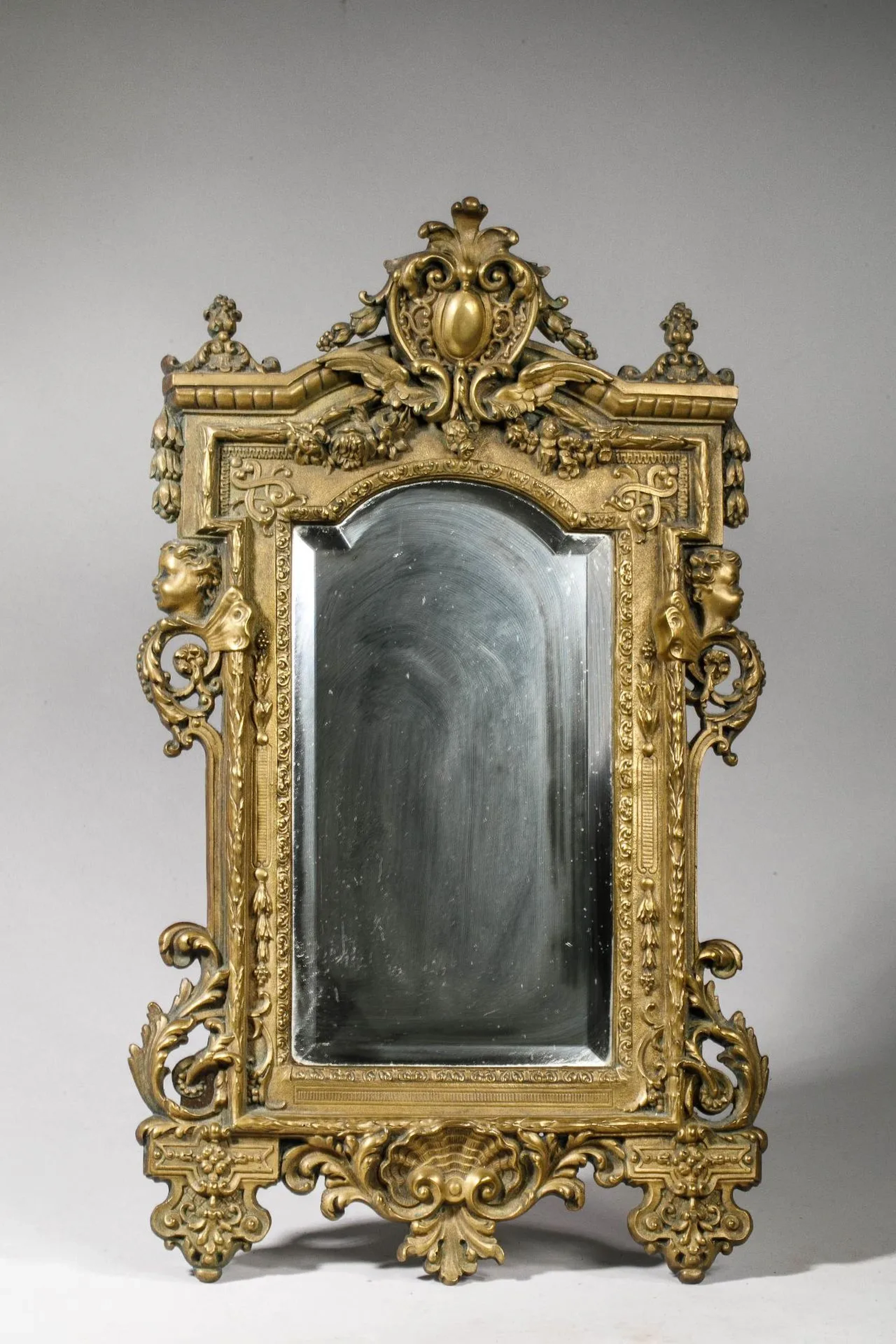 Small Neo-Gothic bronze mirror flanked by cherubs' heads wit - Lot 169