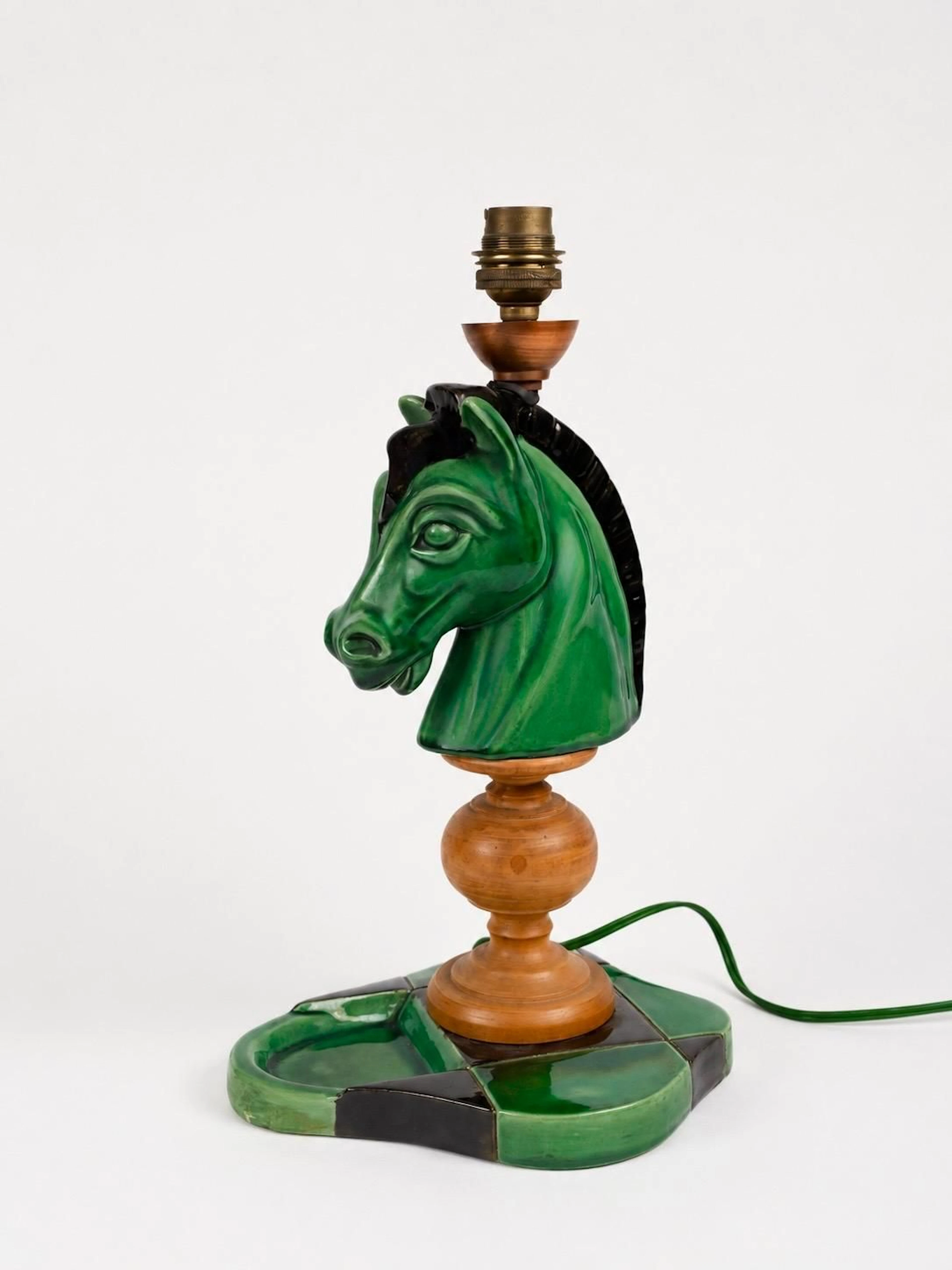 A green and black glazed ceramic lamp base shaped like a hor - Lot 82