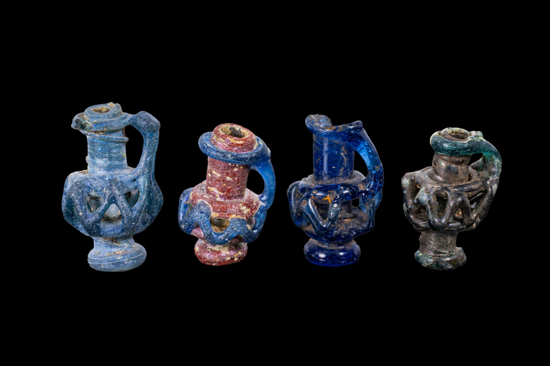 COLLECTION OF LATE ROMAN GLASS MINIATURE JUG-SHAPED PENDANTS