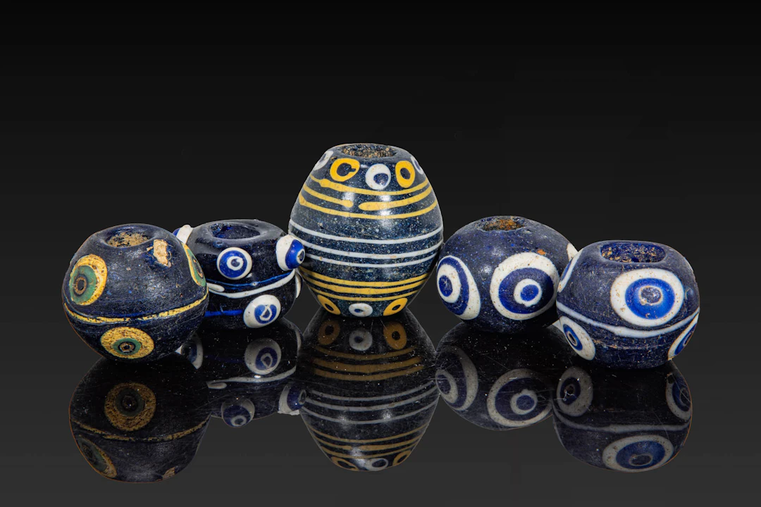 COLLECTION OF LARGE PHOENICIAN POLYCHROME GLASS EYE BEADS