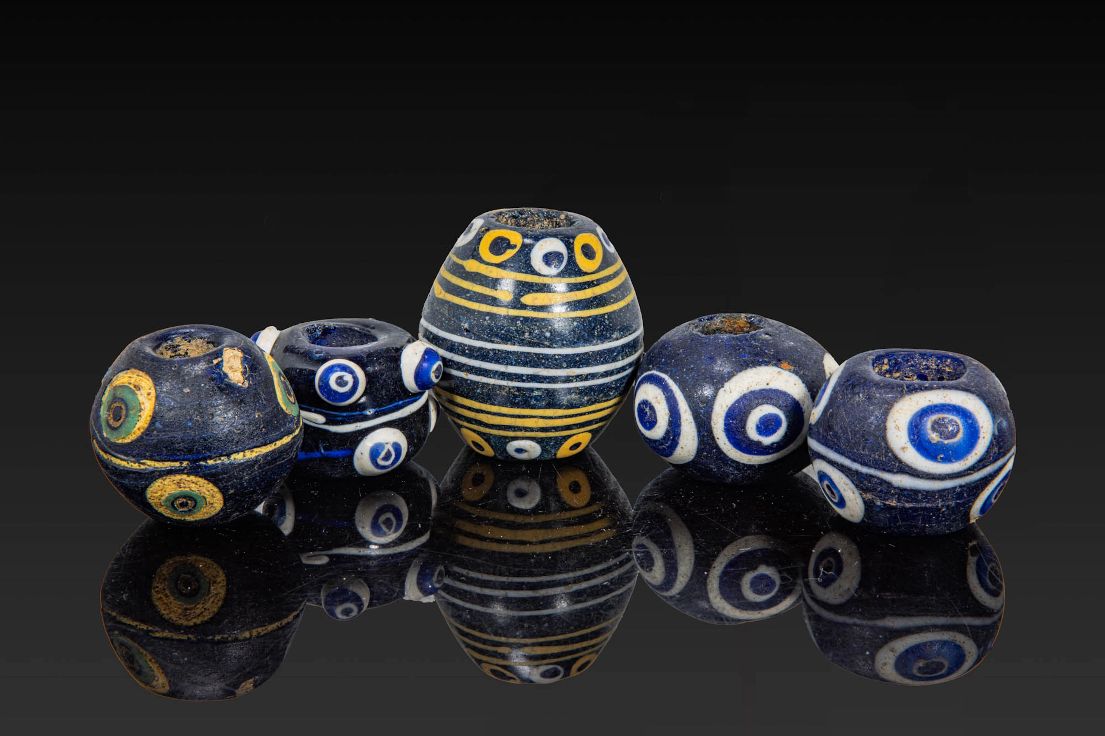 COLLECTION OF LARGE PHOENICIAN POLYCHROME GLASS EYE BEADS
