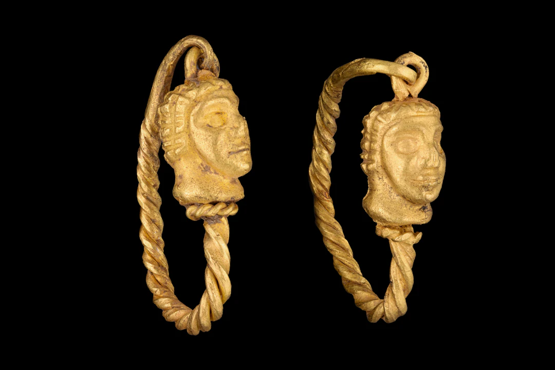 MATCHED PAIR OF HELLENISTIC GOLD EARRINGS WITH MALE HEADS