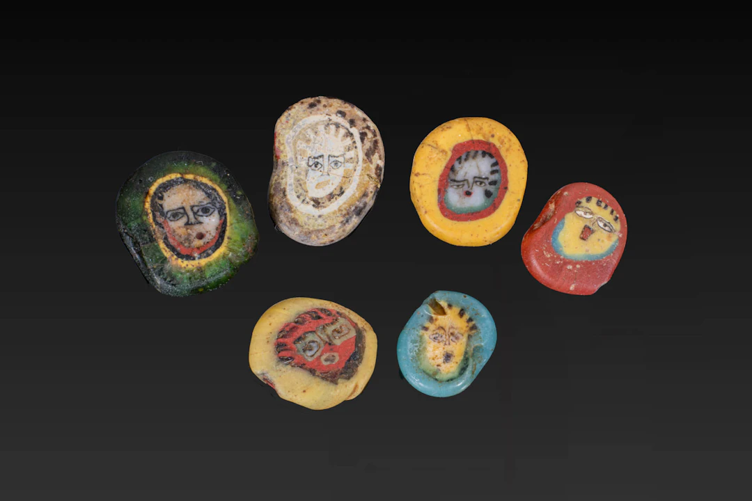 COLLECTION OF ROMAN MOSAIC GLASS BEADS WITH FACES