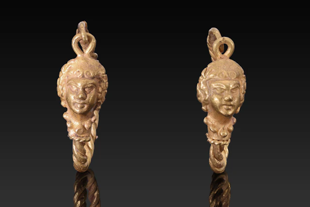 MATCHED PAIR OF HELLENISTIC GOLD EARRINGS WITH EROS HEADS