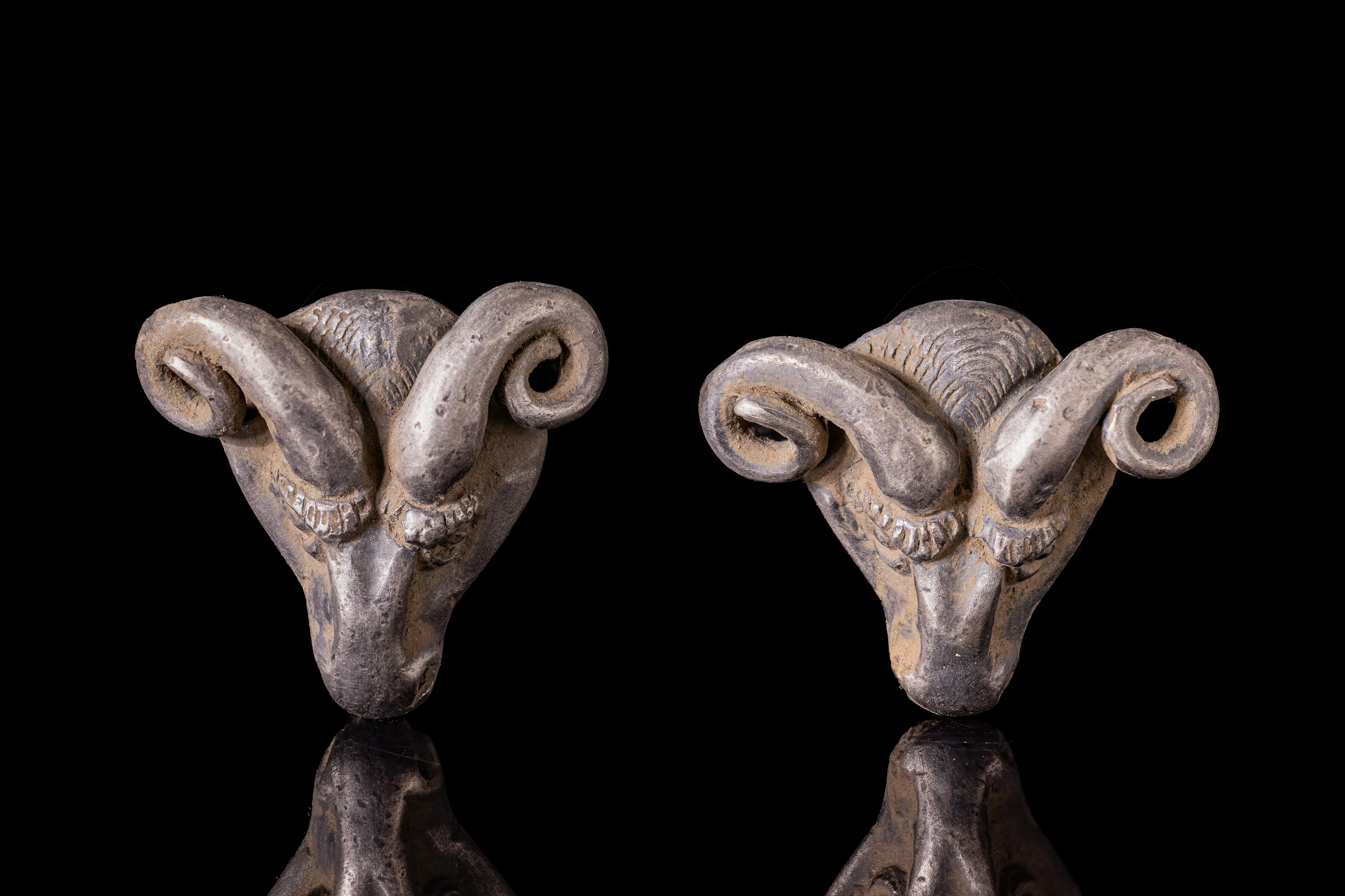 PAIR OF GREEK SILVER RAM-SHAPED APPLIQUES