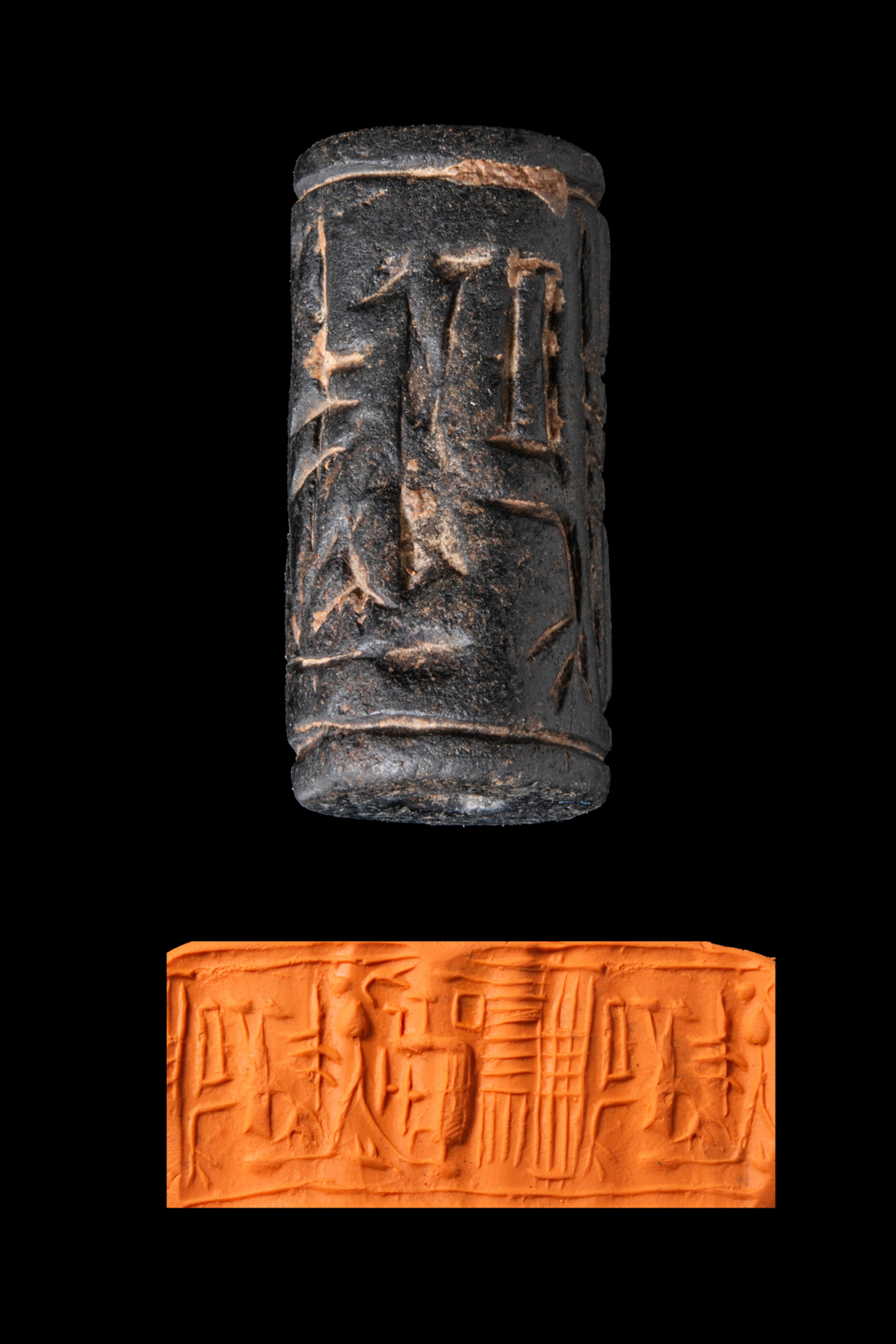 CYPRIOT BLACK STONE CYLINDER SEAL WITH SEATED FIGURE