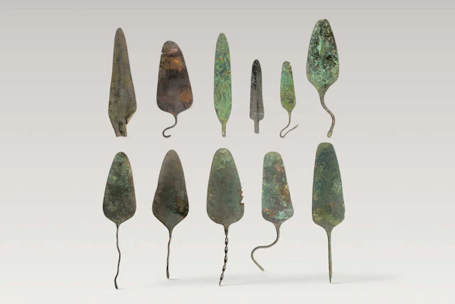 COLLECTION OF BRONZE SPATULAE AND SPEARHEADS