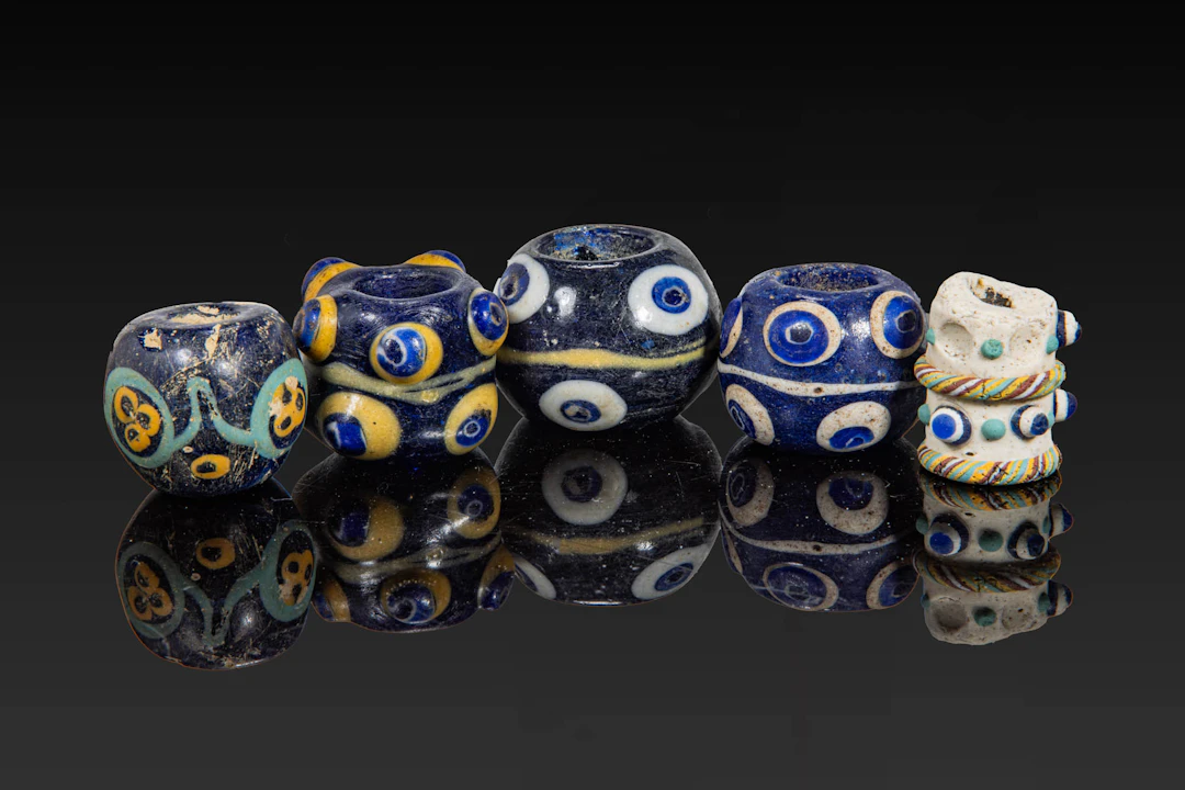COLLECTION OF LARGE PHOENICIAN POLYCHROME GLASS EYE BEADS