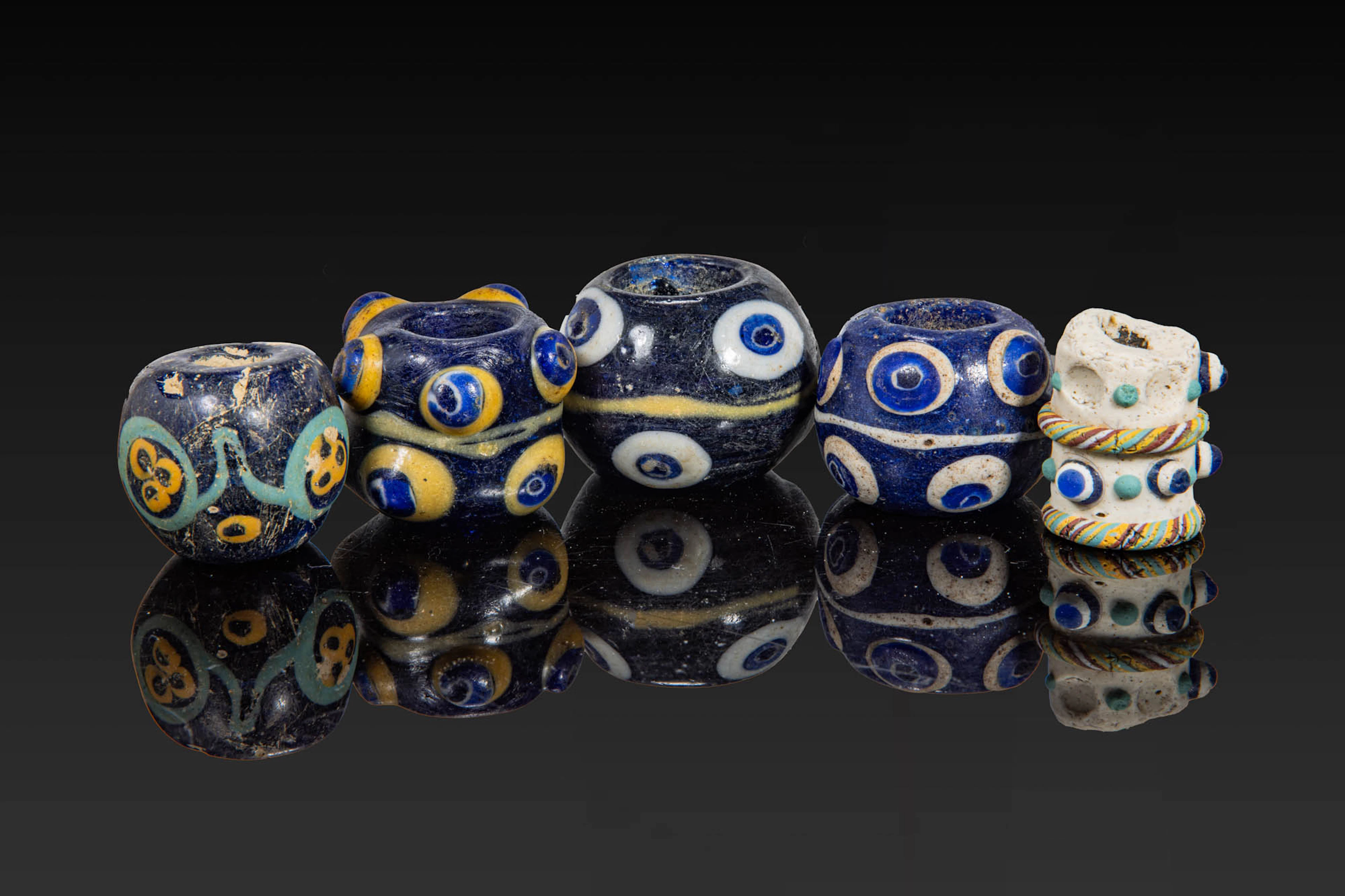 COLLECTION OF LARGE PHOENICIAN POLYCHROME GLASS EYE BEADS