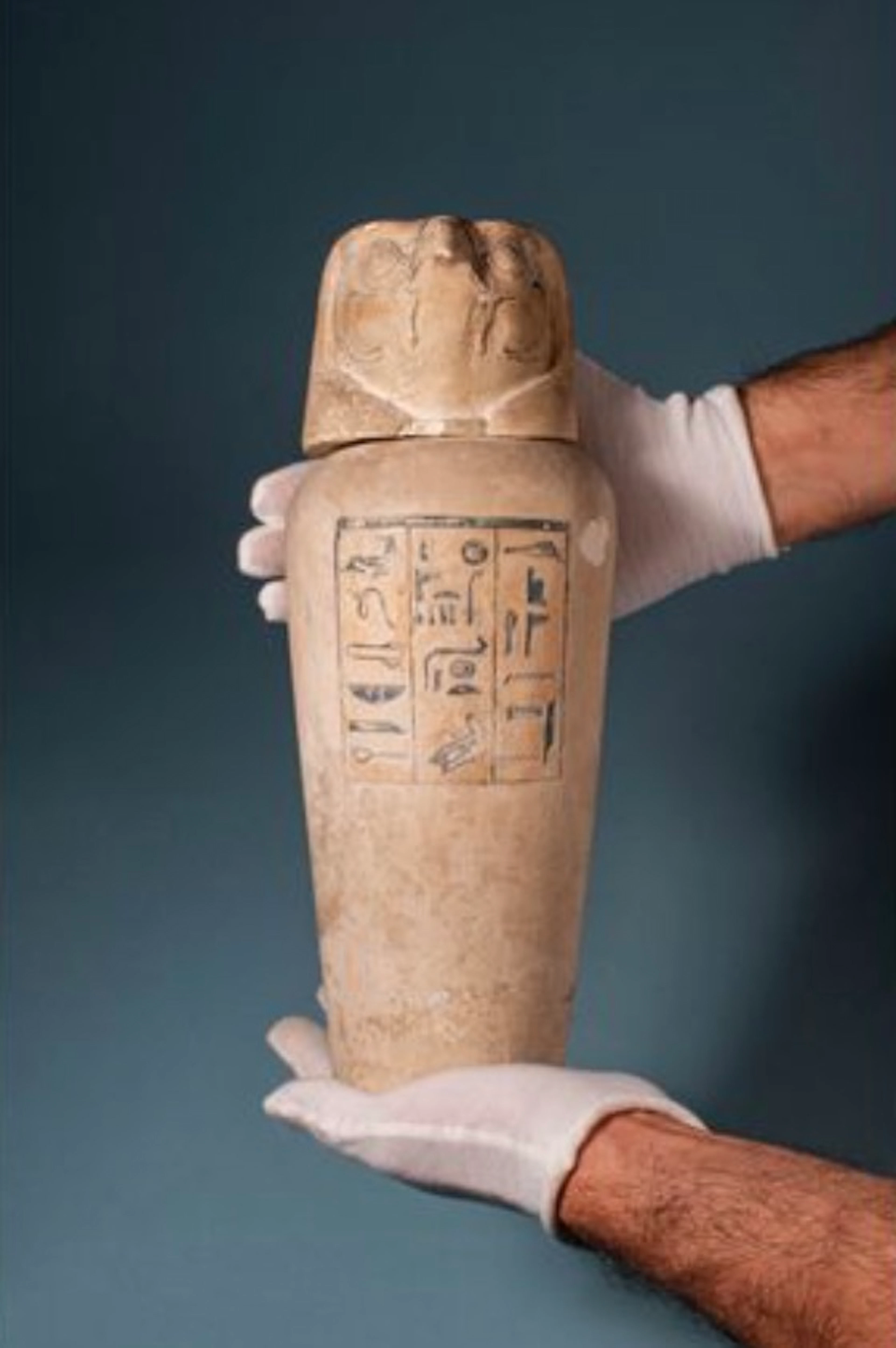 RARE EGYPTIAN LIMESTONE CANOPIC JAR WITH INSCRIPTION AND FALCON-HEADED LID