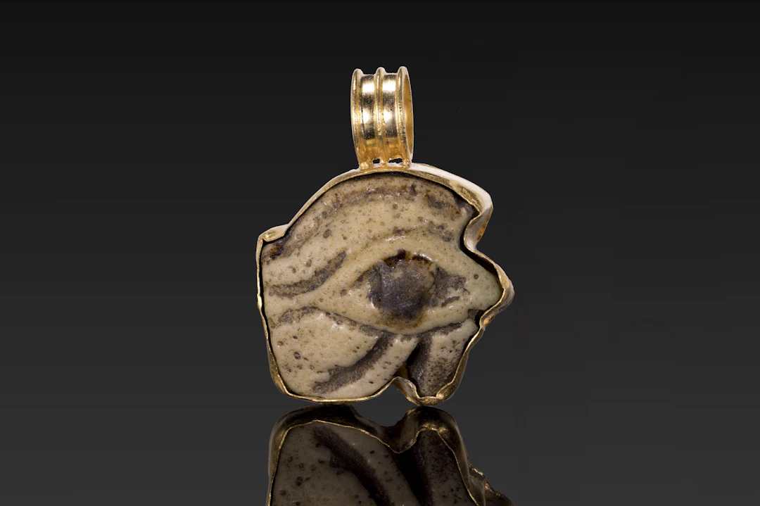 EGYPTIAN BICHROME FAIENCE EYE AMULET IN GOLD PENDANT