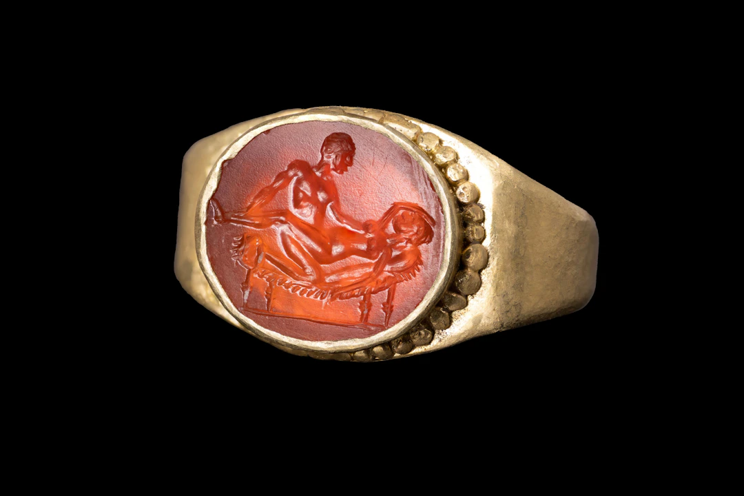 ROMAN CARNELIAN INTAGLIO WITH EROTIC SCENE IN GOLD RING