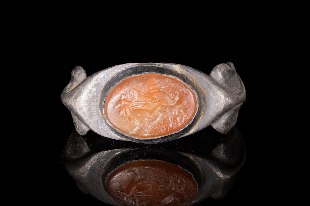ROMAN CARNELIAN INTAGLIO WITH EROS DRIVING A CHARIOT DRAWN BY ROOSTERS