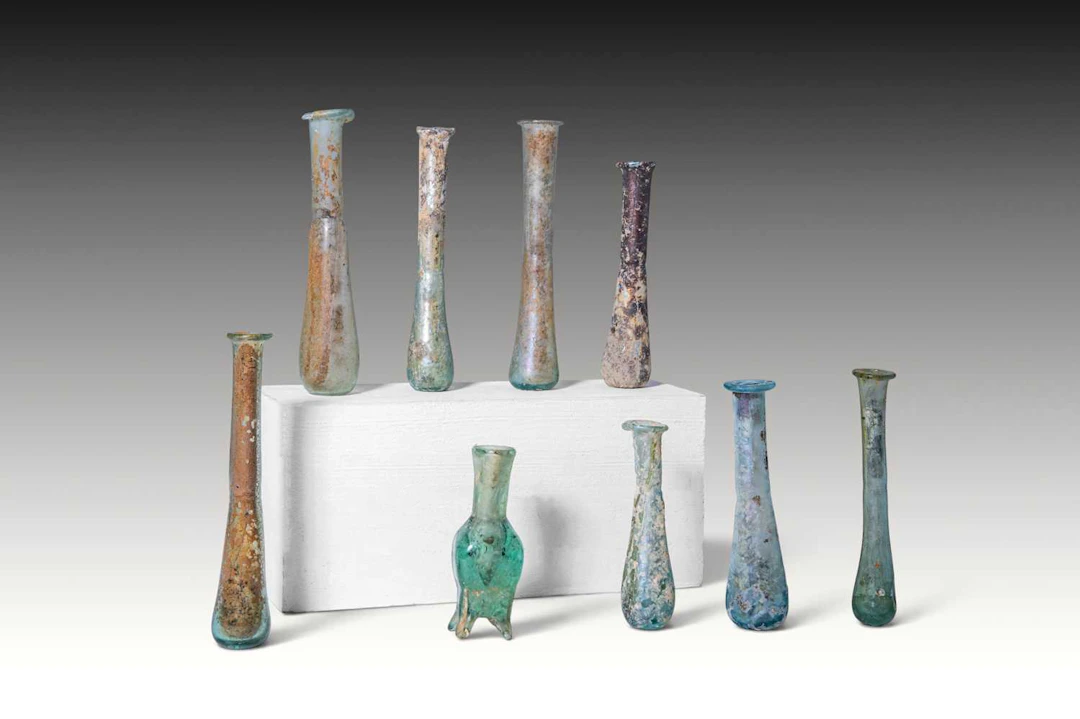 COLLECTION OF NINE ROMAN AND LATE ROMAN GLASS UNGUENTARIA