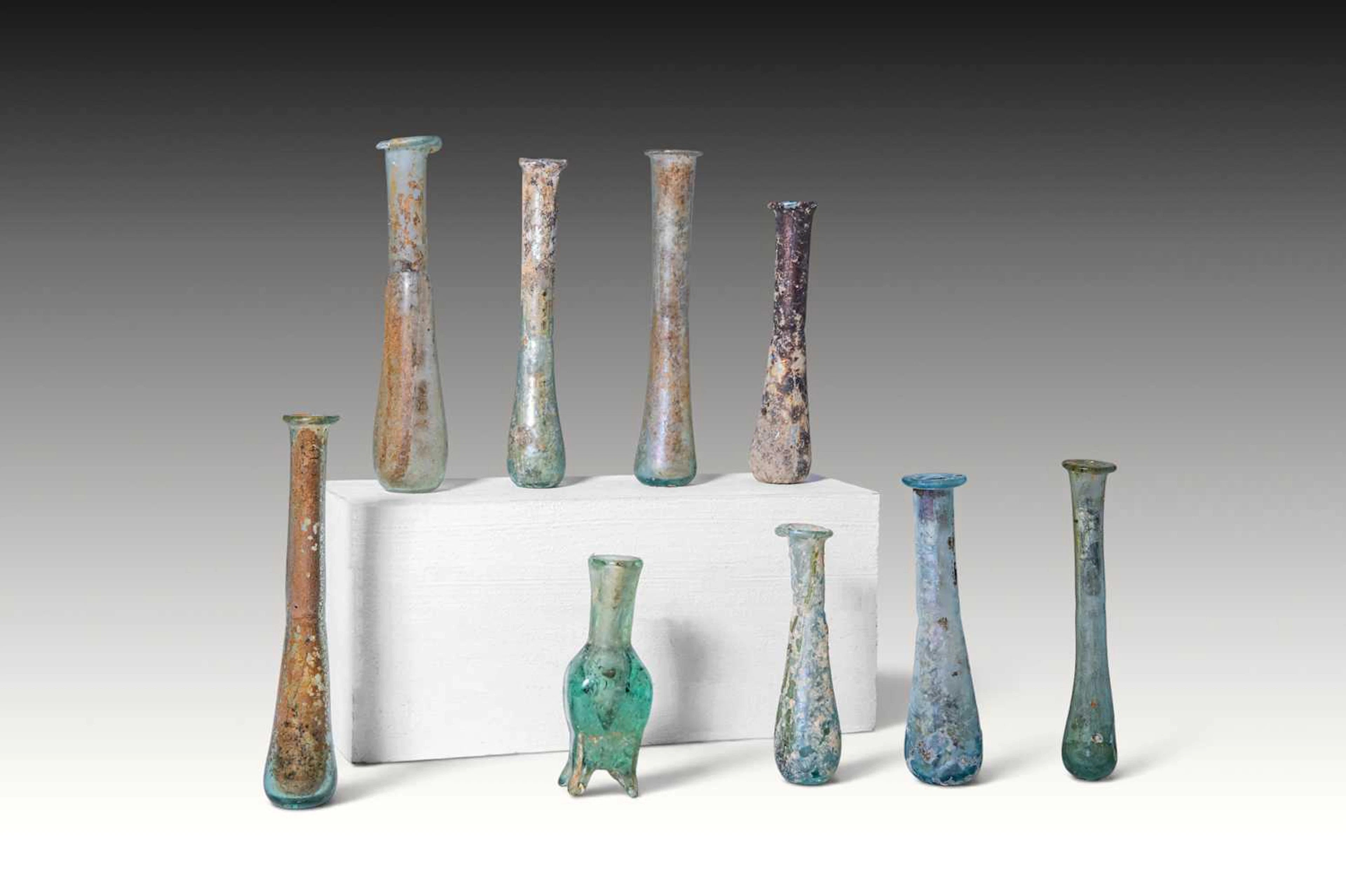 COLLECTION OF NINE ROMAN AND LATE ROMAN GLASS UNGUENTARIA