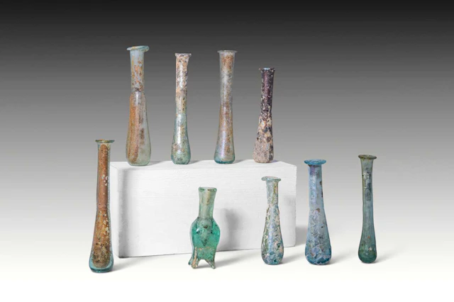 COLLECTION OF NINE ROMAN AND LATE ROMAN GLASS UNGUENTARIA