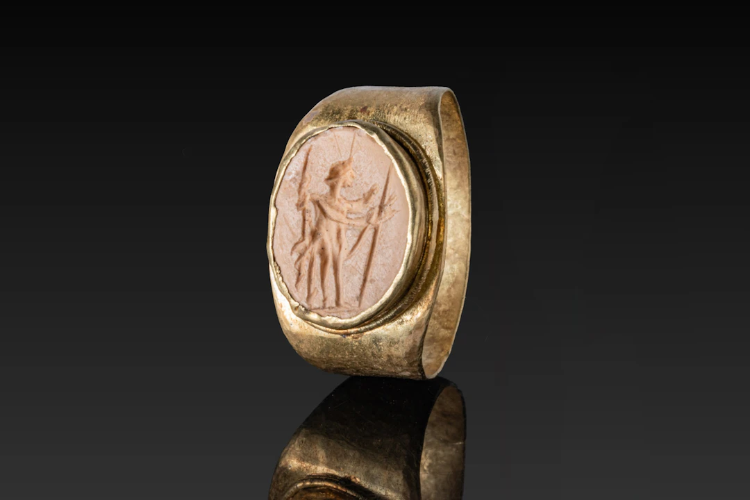 ROMAN CREAMSTONE INTAGLIO OF A CROWNED GOD IN HIGH KARAT GOLD RING