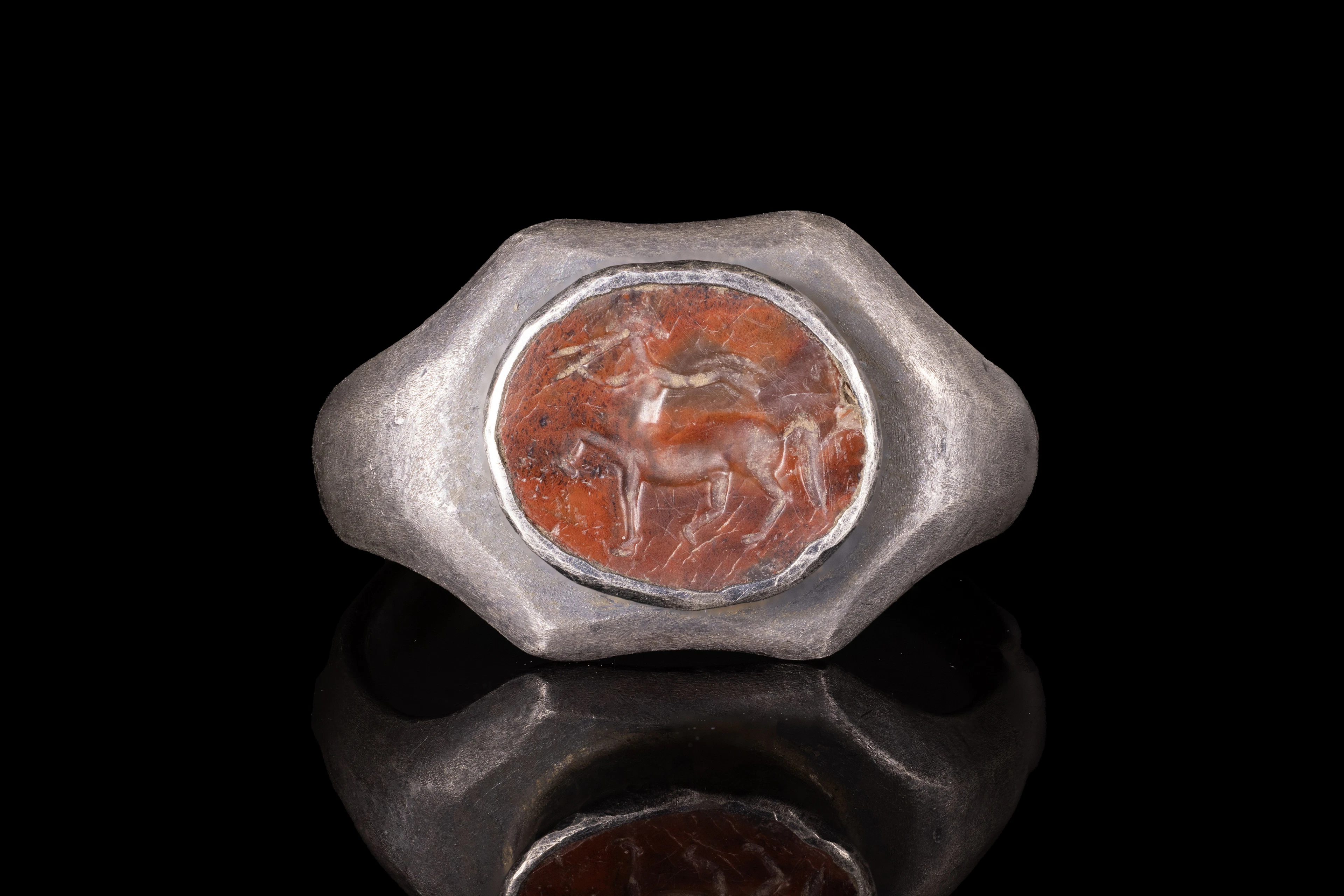 ROMAN CARNELIAN INTAGLIO WITH CENTAUR PLAYING FLUTE IN SILVER RING