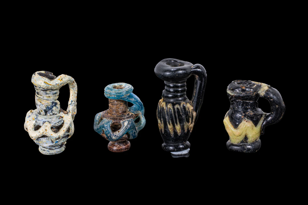 COLLECTION OF LATE ROMAN GLASS MINIATURE JUG-SHAPED PENDANTS