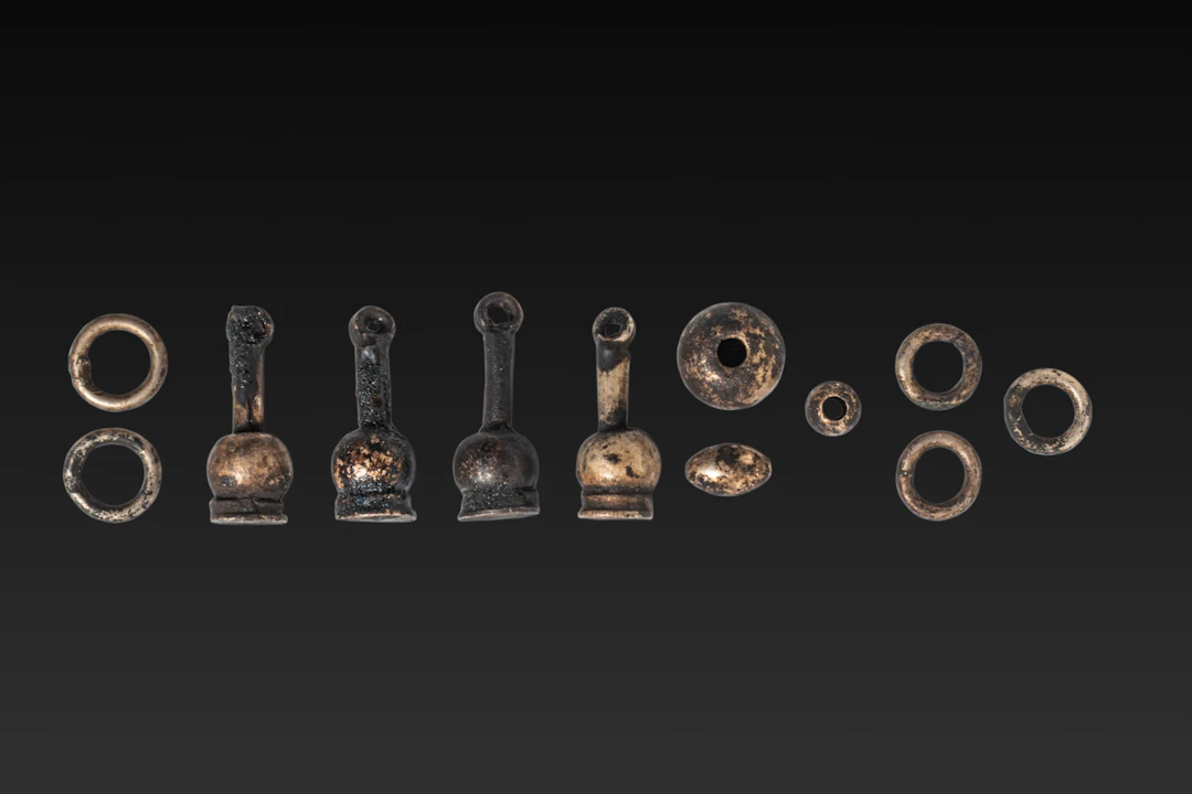 COLLECTION OF EGYPTIAN SILVER AMULETS AND BEADS