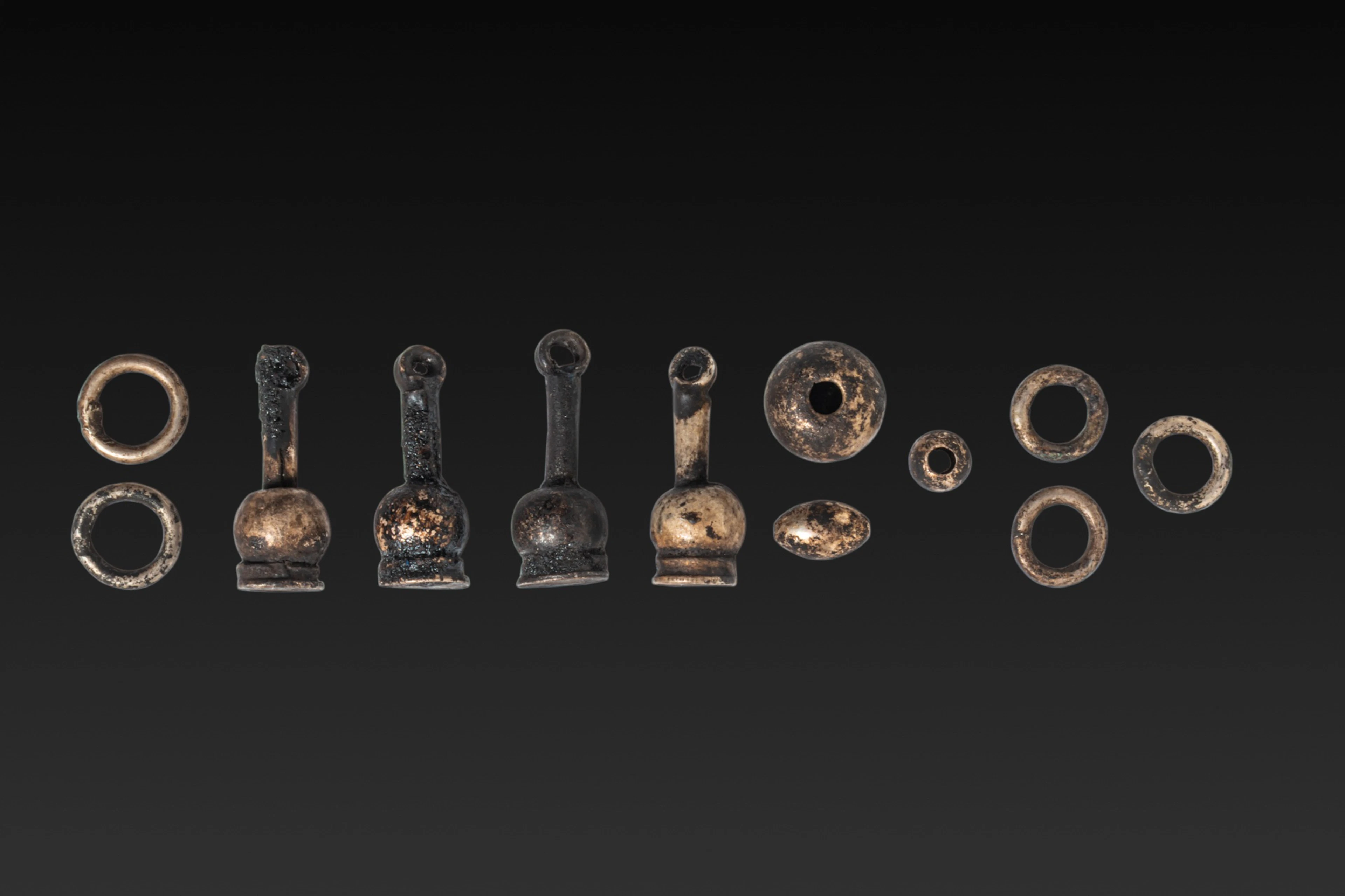 COLLECTION OF EGYPTIAN SILVER AMULETS AND BEADS
