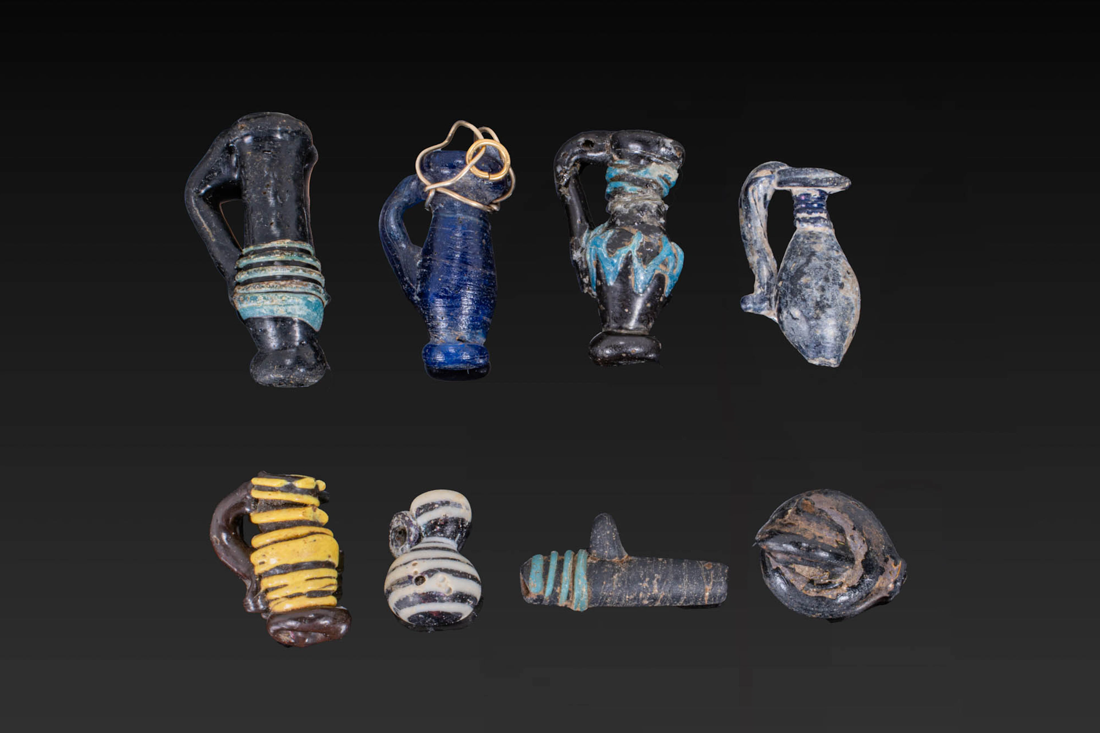 COLLECTION OF LATE ROMAN GLASS PENDANTS