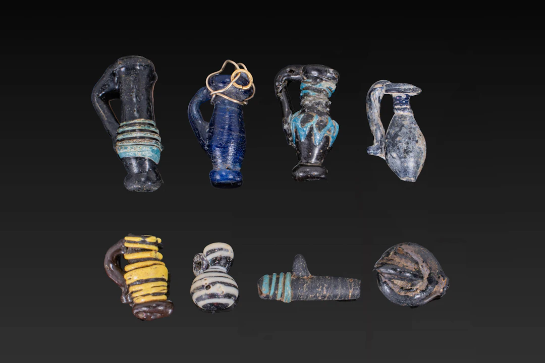 COLLECTION OF LATE ROMAN GLASS PENDANTS
