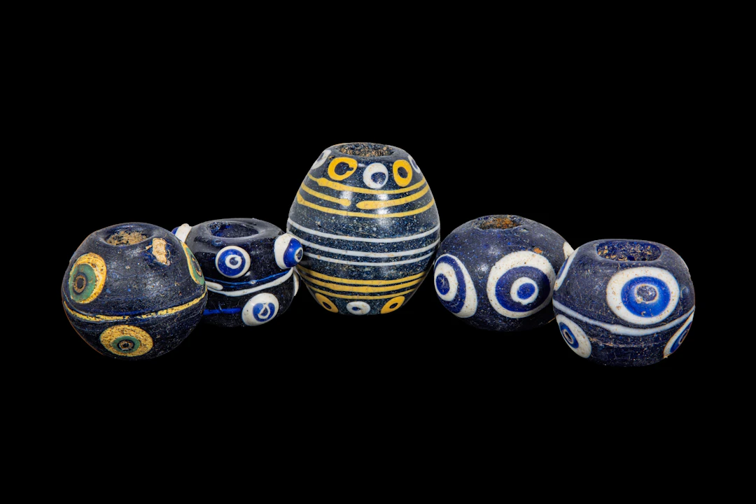 COLLECTION OF LARGE PHOENICIAN POLYCHROME GLASS EYE BEADS