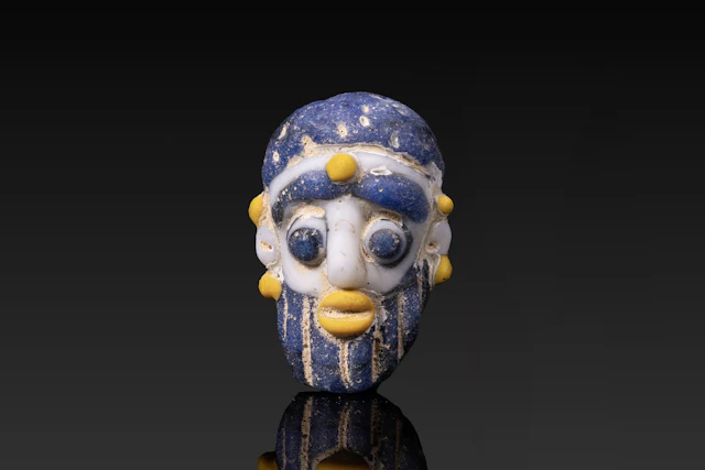 PHOENICIAN POLYCHROME GLASS FACE BEAD