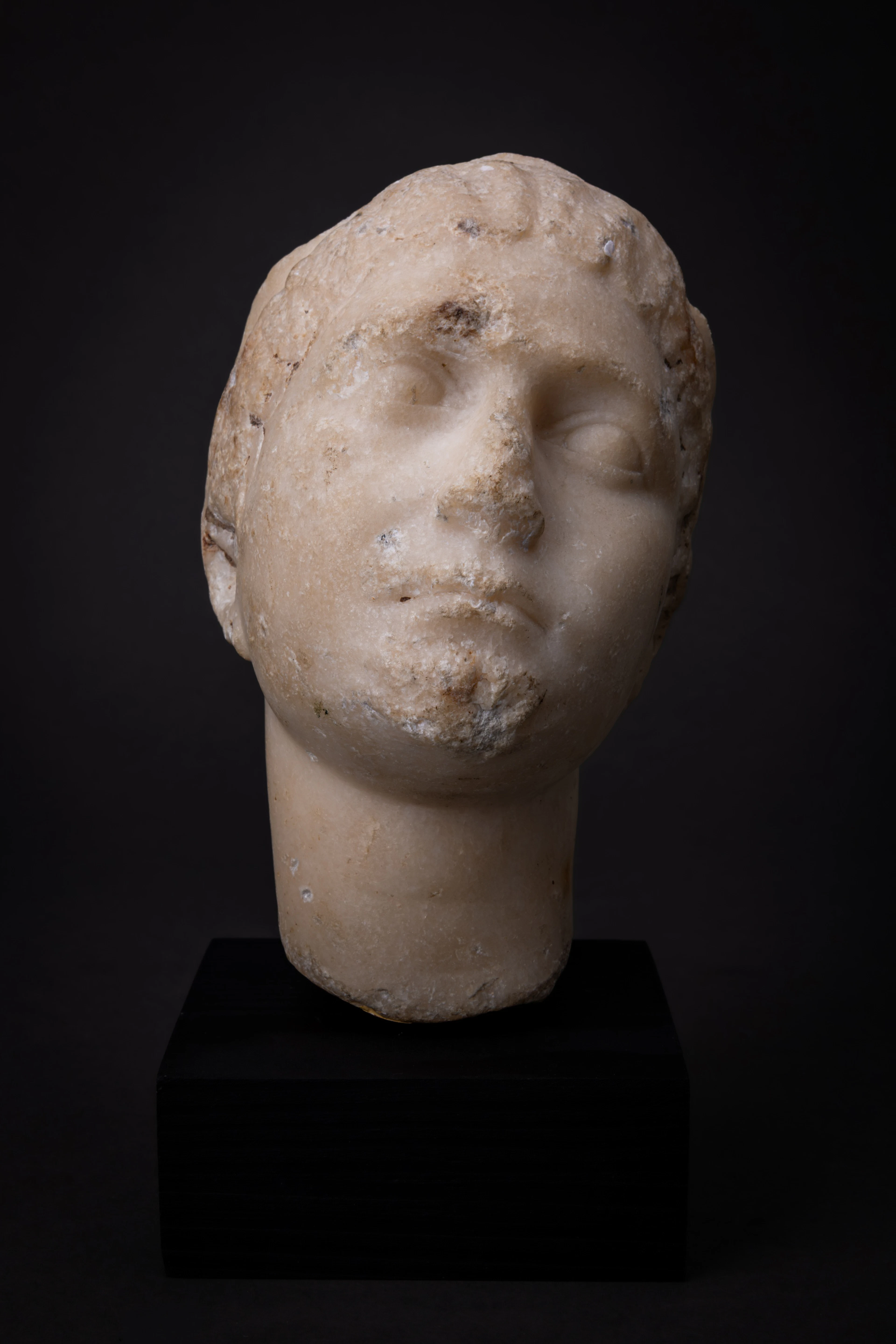 EASTERN ROMAN MARBLE HEAD OF YOUNG WOMAN