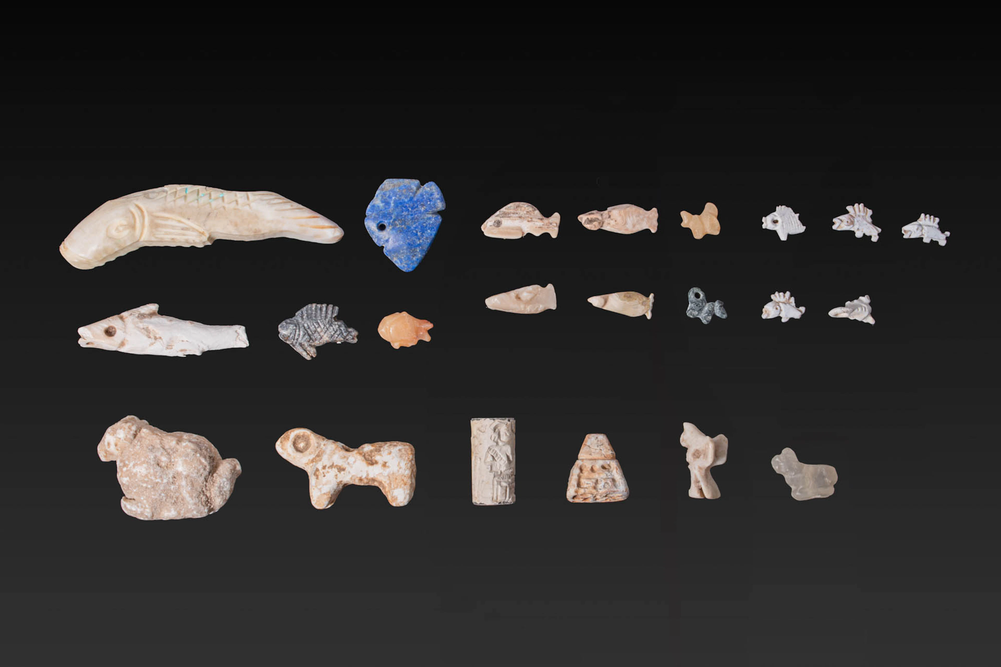 COLLECTION OF MESOPOTAMIAN SHELL AND STONE ANIMAL AMULETS, AND AN