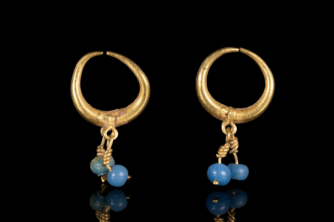 MATCHED PAIR OF HELLENISTIC GOLD AND GLASS EARRINGS