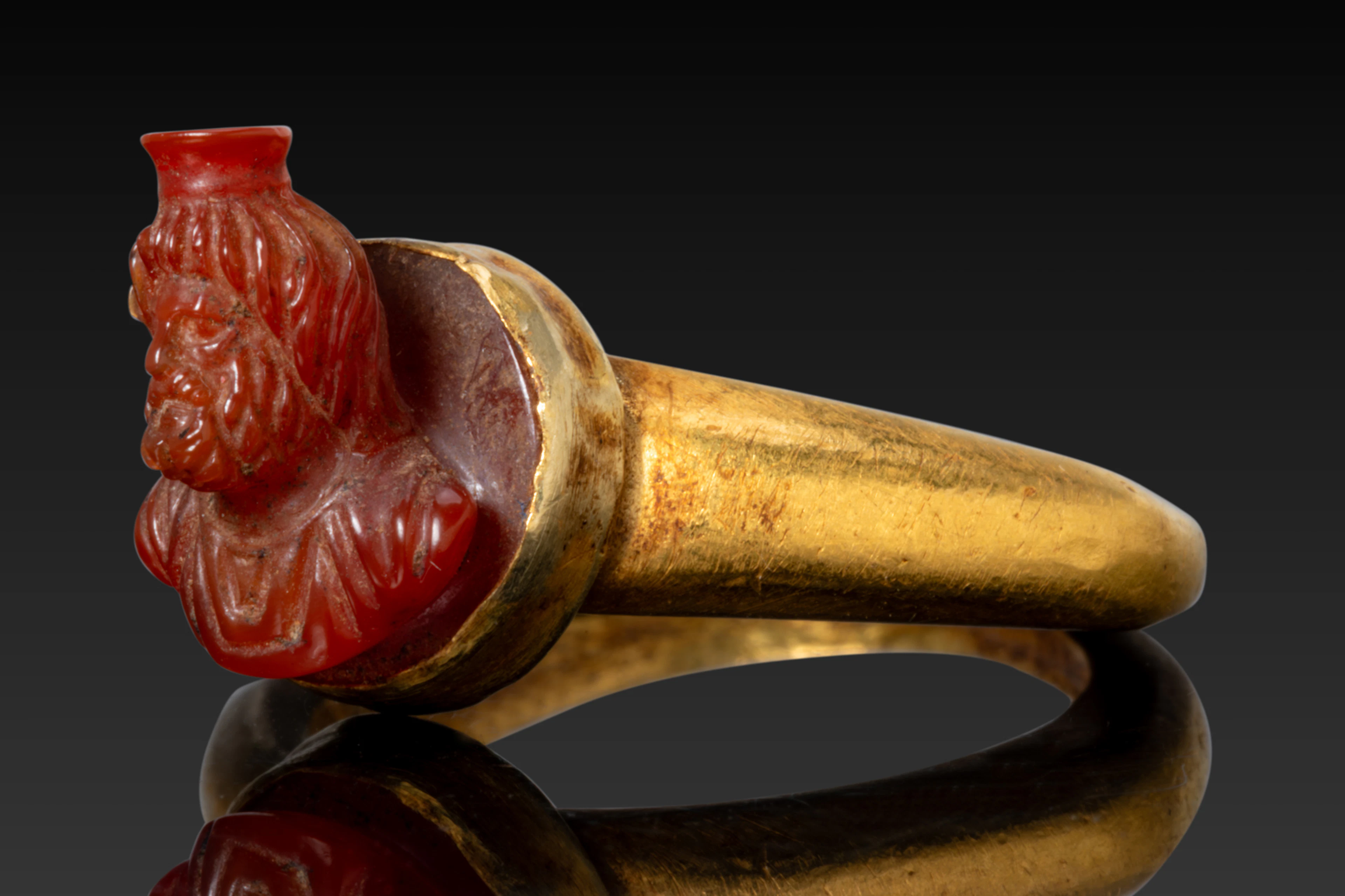 ANCIENT ROMAN HIGH KARAT GOLD RING WITH CARNELIAN BUST OF SERAPIS