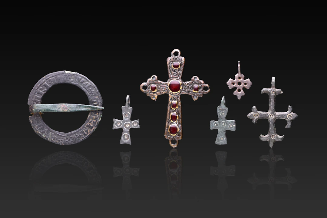 COLLECTION OF MEDIEVAL BRONZE CROSS PENDANTS, A GARNET-SET CROSS PENDANT