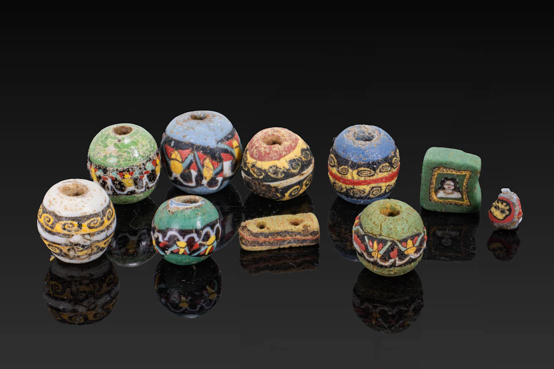 COLLECTION OF ROMAN MOSAIC GLASS BEADS WITH GEOMETRIC AND FIGURAL MOTIFS