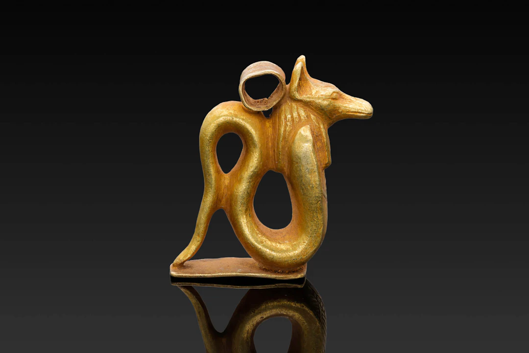 RARE EGYPTIAN GOLD PENDANT IN THE FORM OF A JACKAL-HEADED COBRA