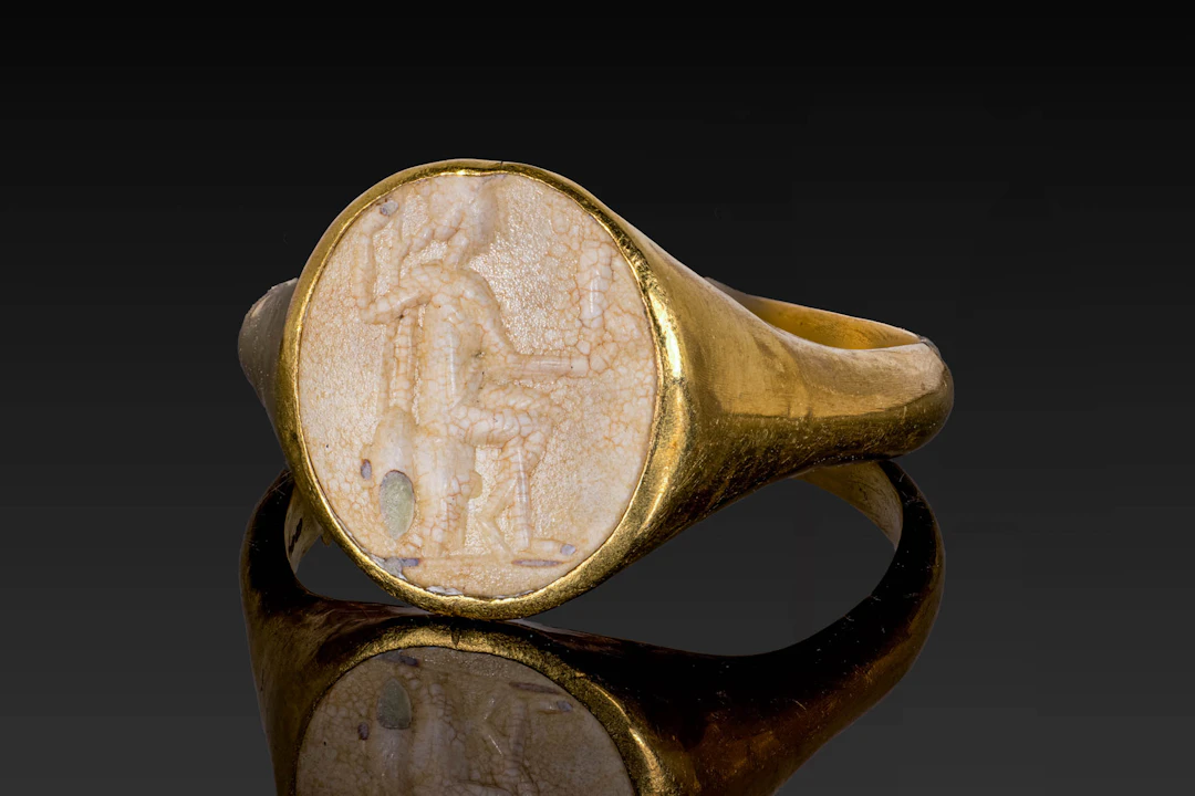 ROMAN STONE INTAGLIO OF MINERVA HOLDING VICTORY IN GOLD RING