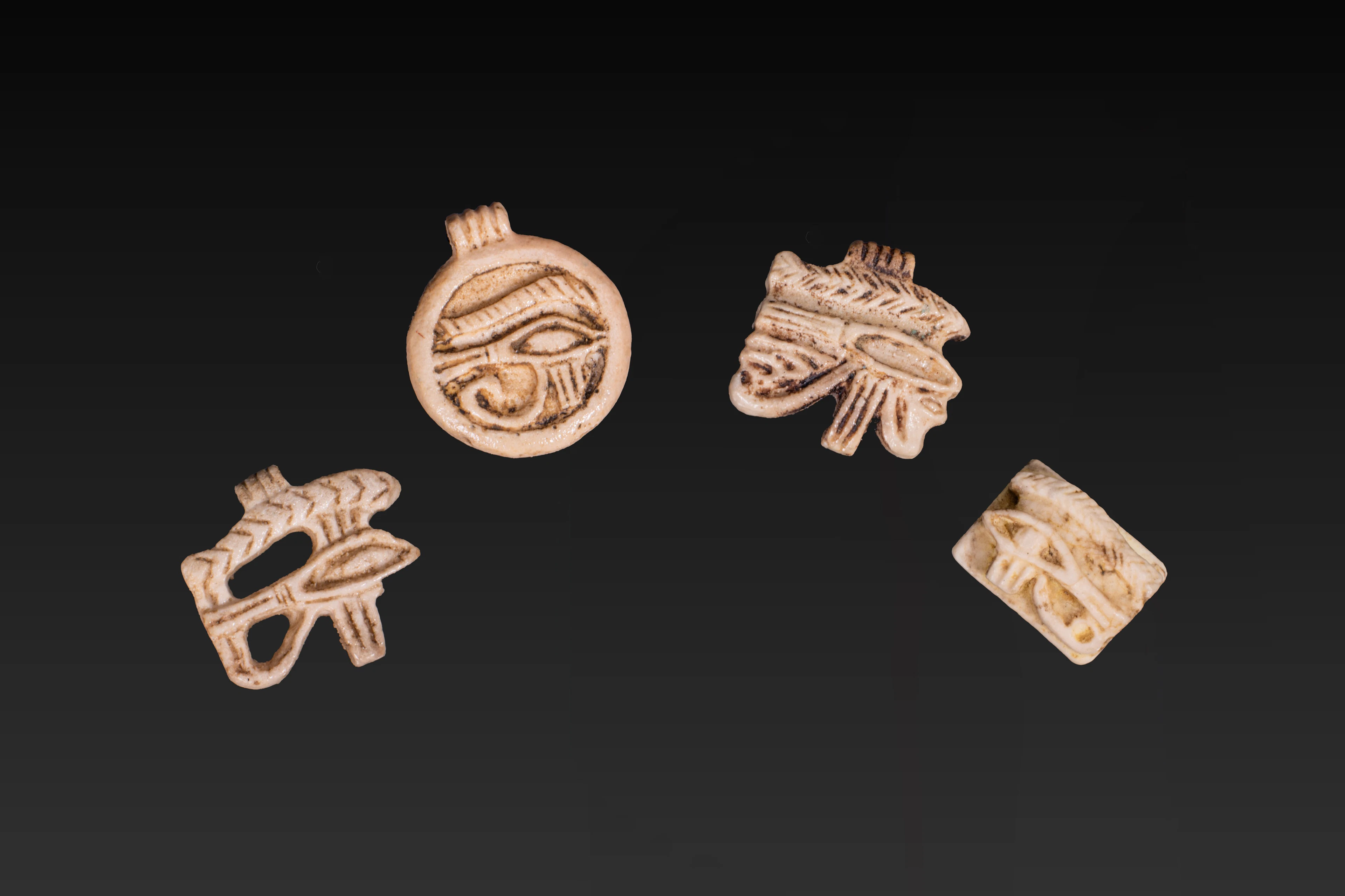 COLLECTION OF EGYPTIAN FAIENCE WADJET AMULETS