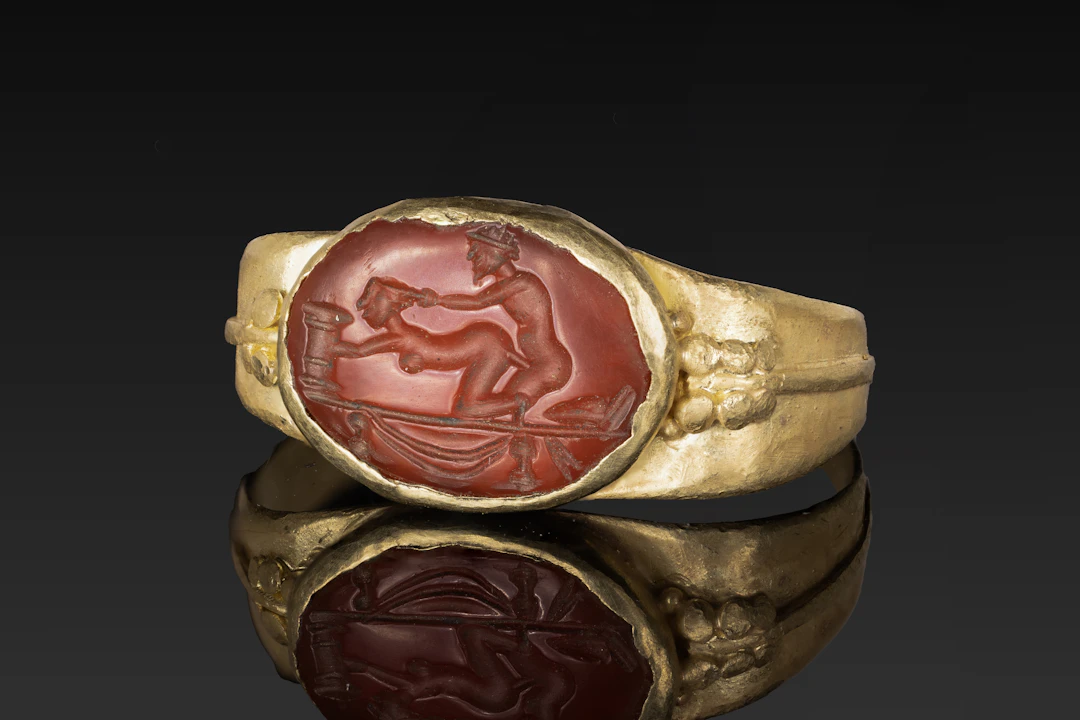 ROMAN CARNELIAN INTAGLIO WITH EROTIC SCENE IN GOLD RING