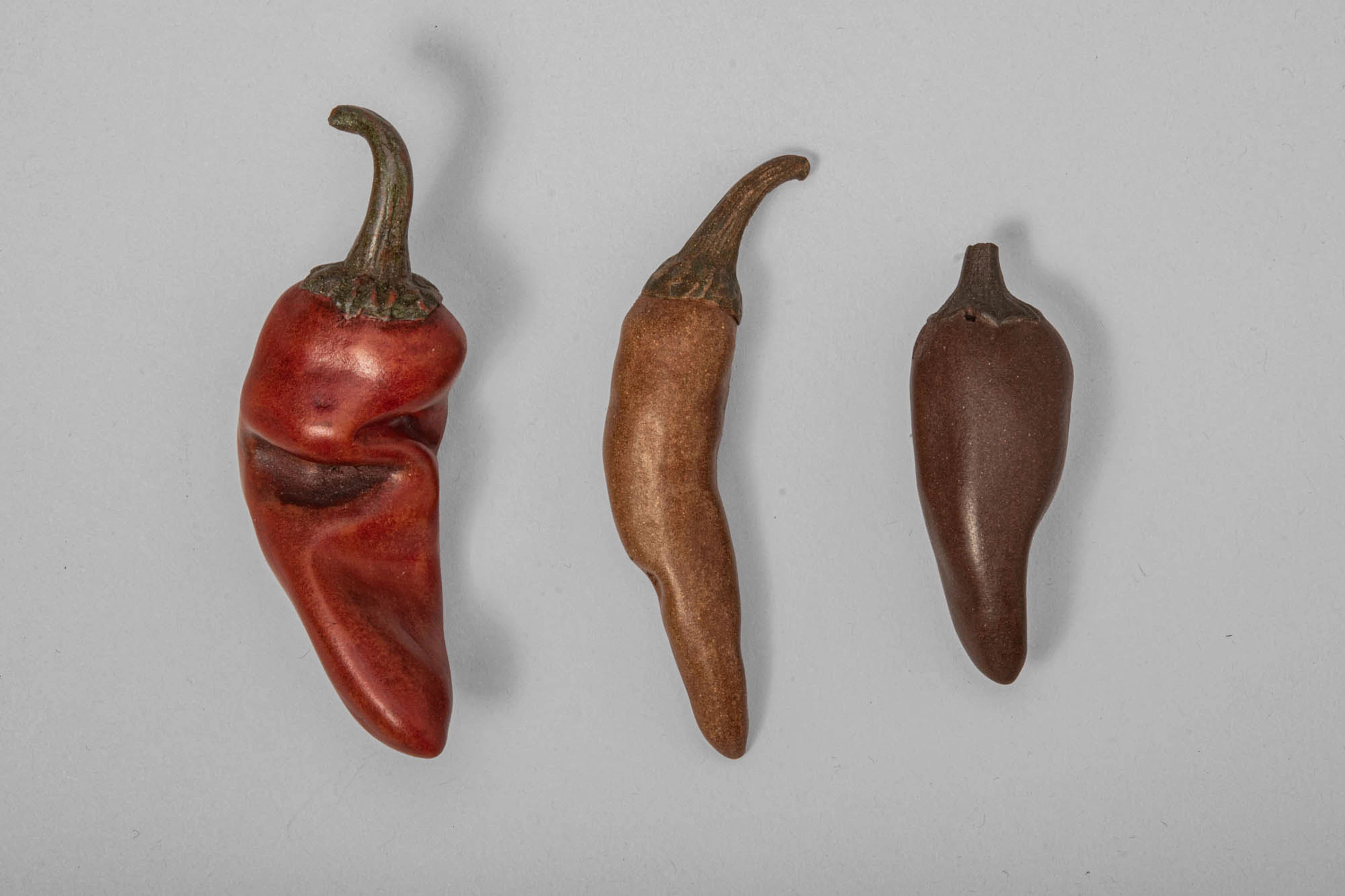 GROUP OF YIXING SCULPTURAL MODELS OF CHILLIES, BY ZHOU DINGFANG
