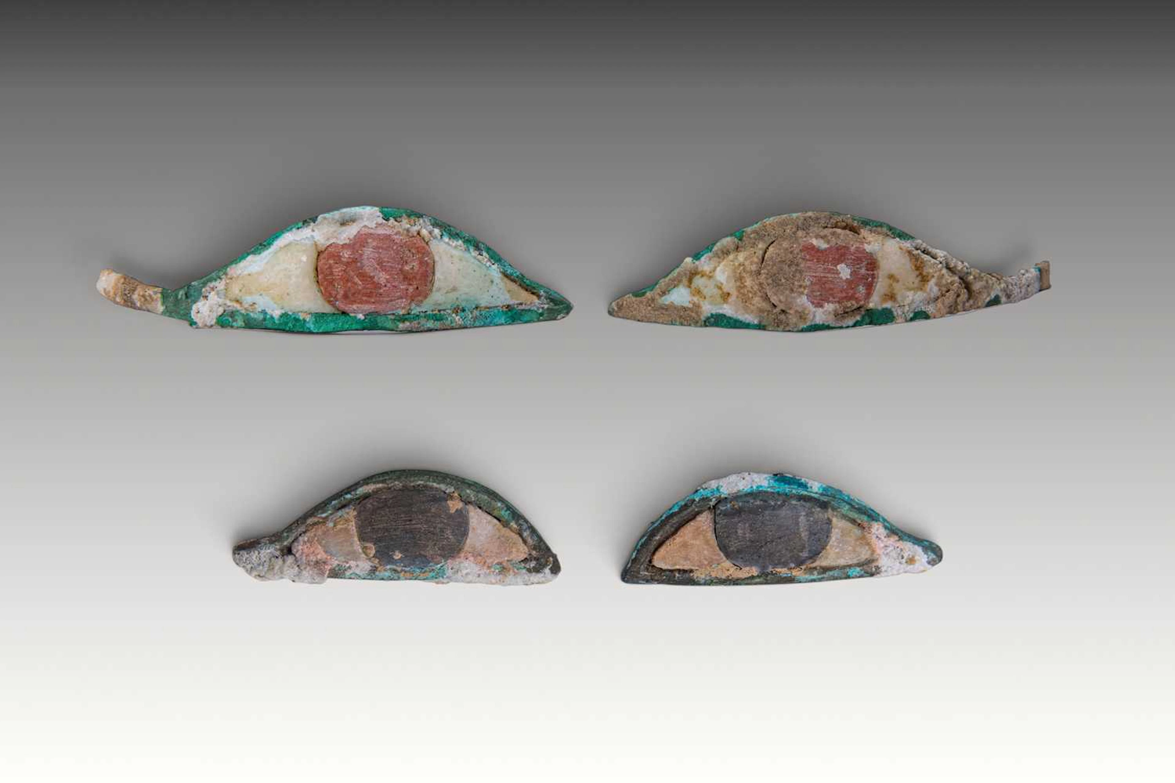 TWO PAIRS OF EGYPTIAN BRONZE AND STONE MUMMY EYES