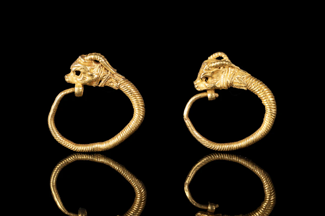 MATCHED PAIR OF GREEK TWISTED GOLD EARRINGS WITH IBEX HEADS