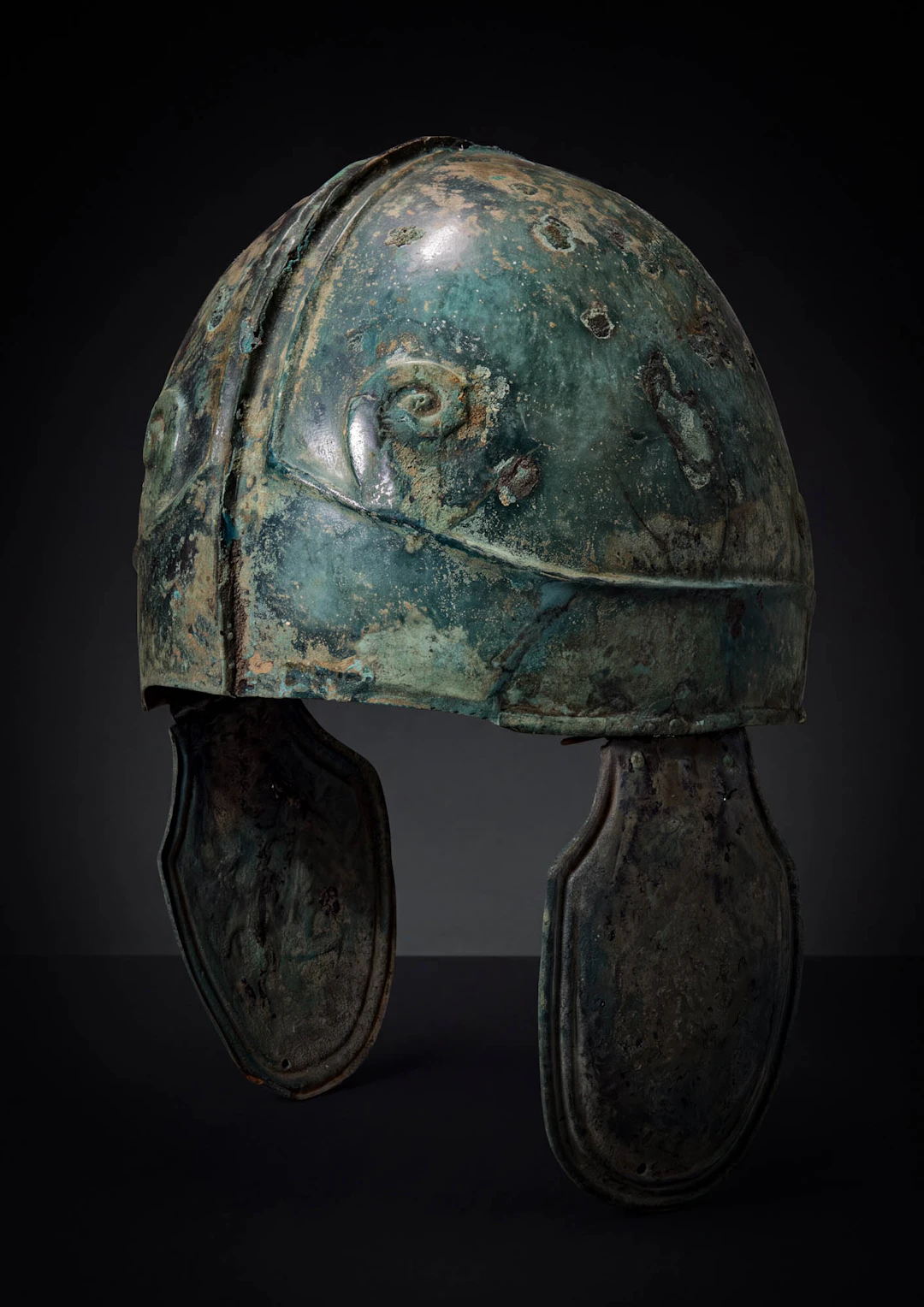 GREEK CHALCIDIAN BRONZE HELMET WITH ZEUS AMMON HORNS AND CHEEKPIECES