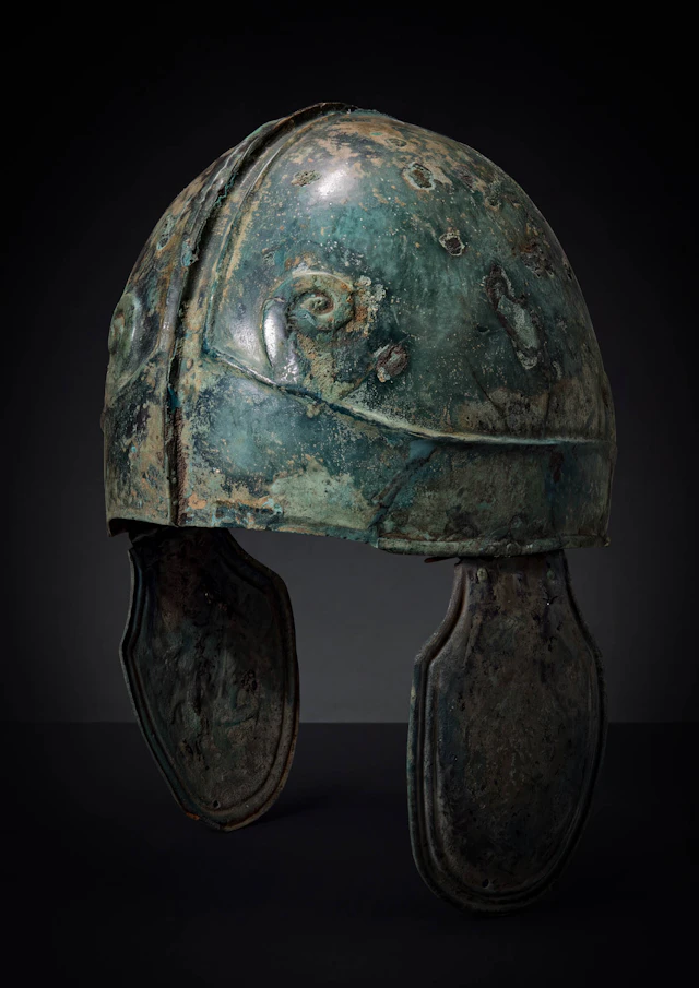 GREEK CHALCIDIAN BRONZE HELMET WITH ZEUS AMMON HORNS AND CHEEKPIECES