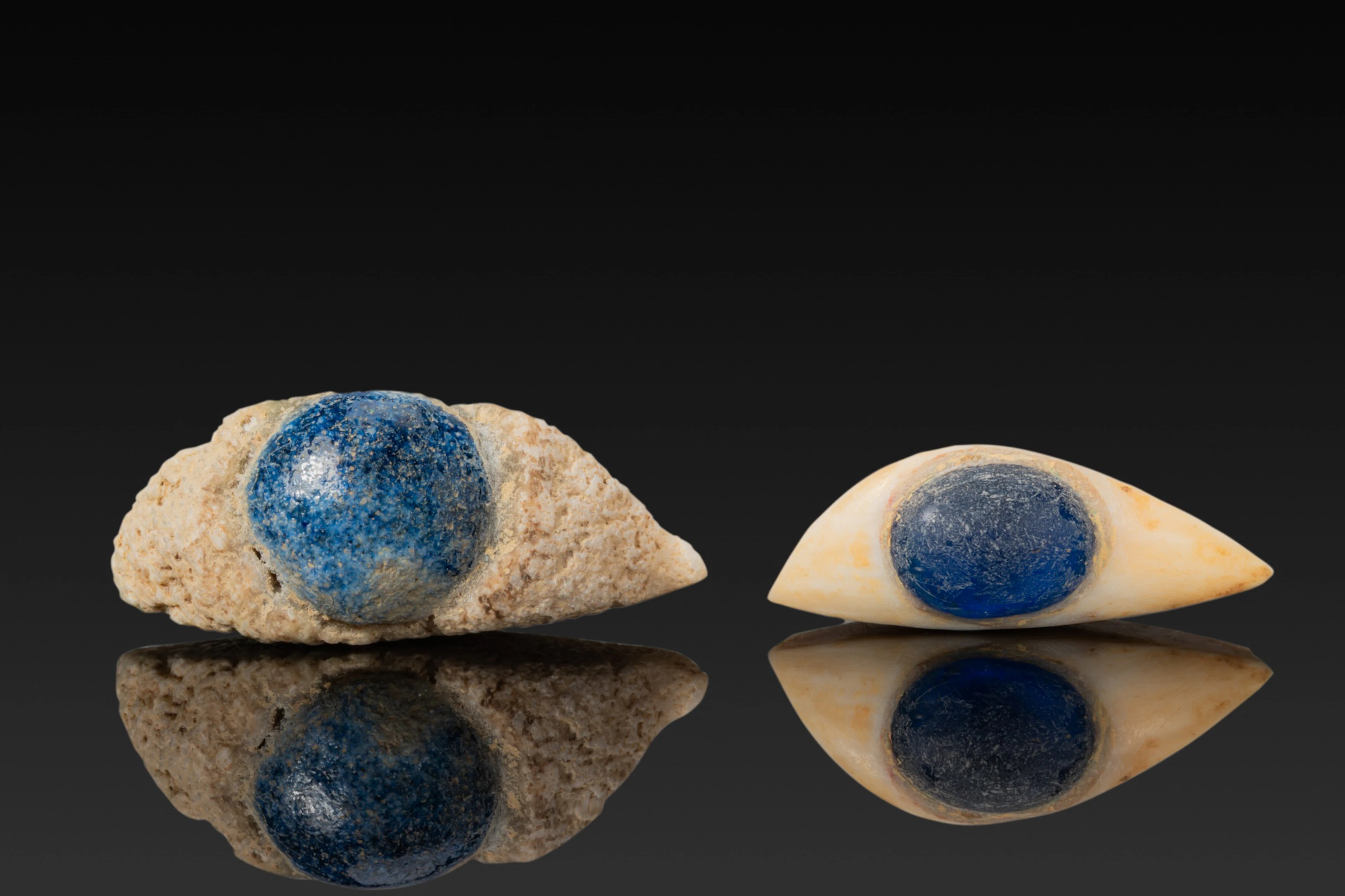 PAIR OF EGYPTIAN STONE AND GLASS EYE INLAYS FROM A MUMMY MASK