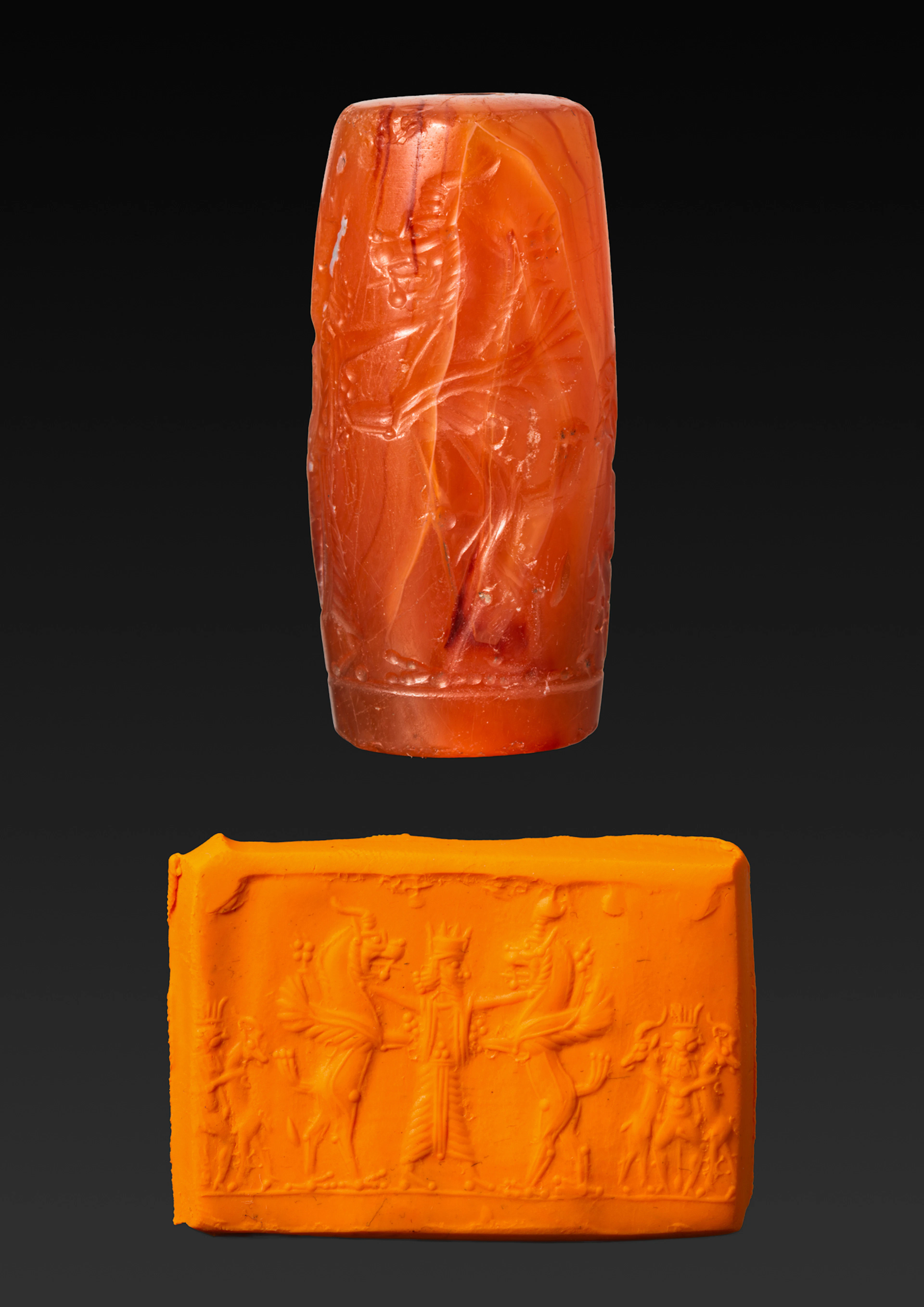 GREEK PERIOD CARNELIAN CYLINDER SEAL WITH A HERO GRASPING GRIFFINS