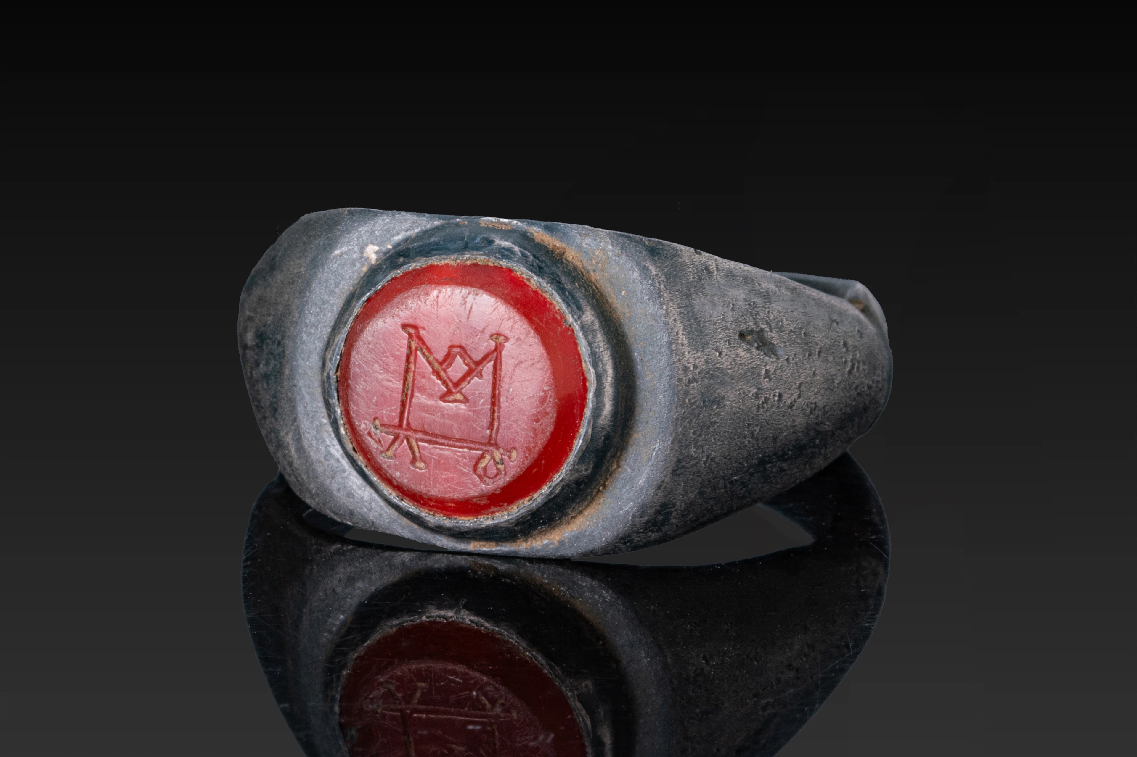 LATE ROMAN CARNELIAN INTAGLIO WITH MONOGRAM IN SILVER RING