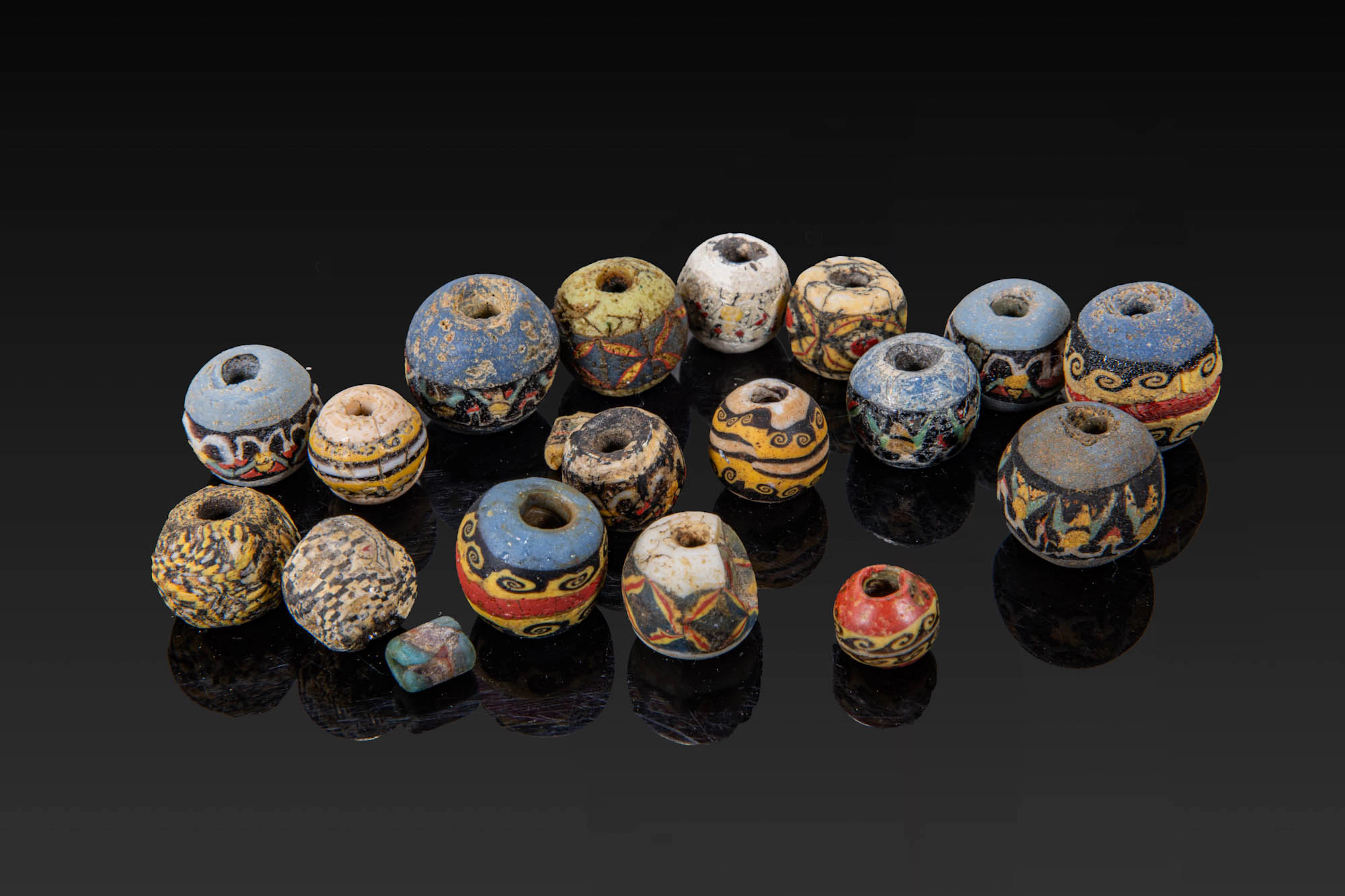 COLLECTION OF ROMAN MOSAIC GLASS BEADS WITH WAVE AND GEOMETRICAL MOTIFS