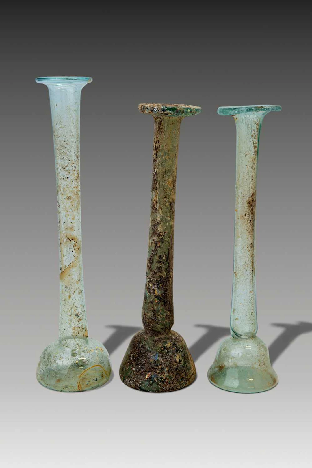 COLLECTION OF ROMAN GLASS TALL UNGUENTARIA