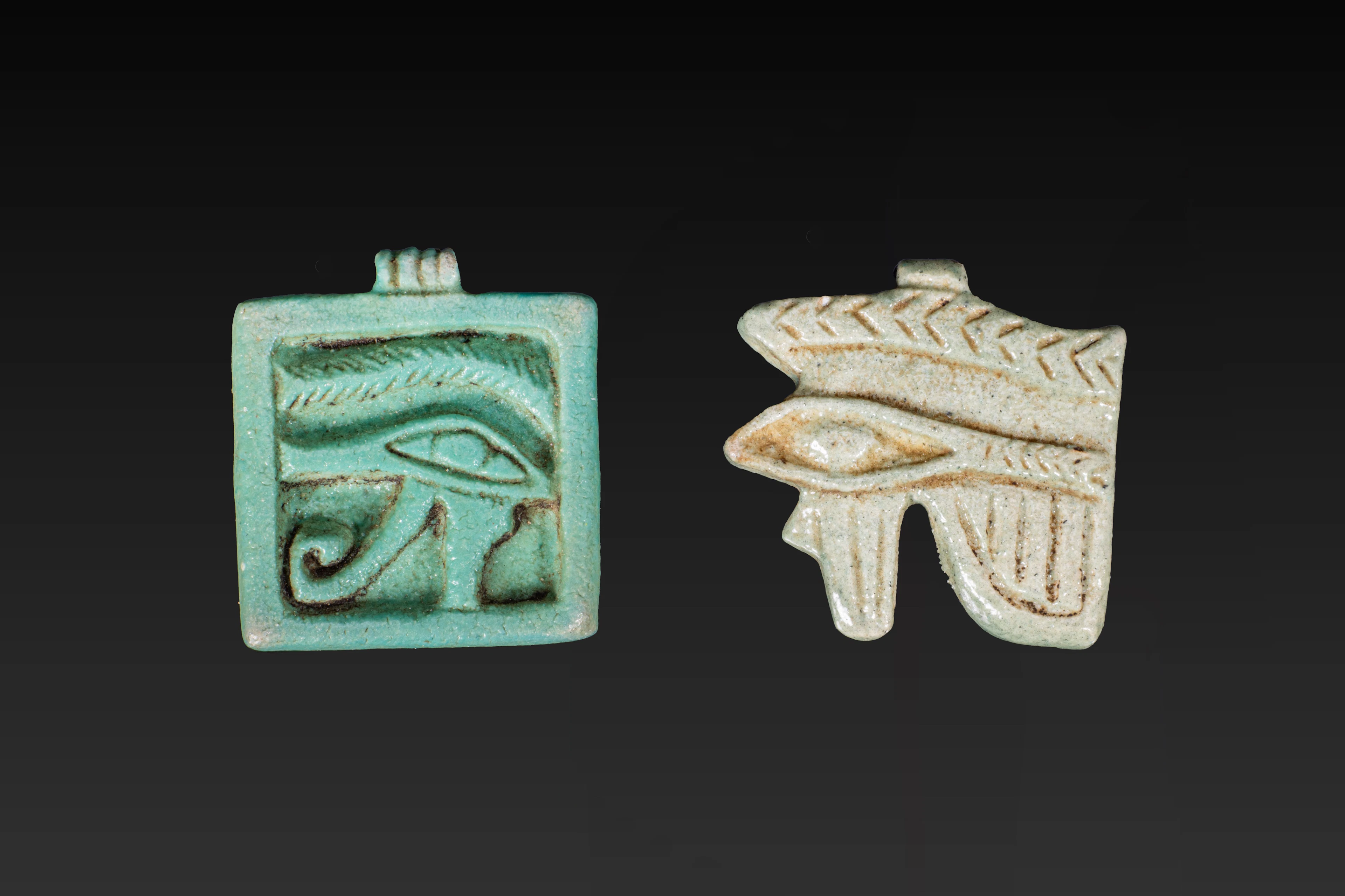 PAIR OF EGYPTIAN FAIENCE WADJET AMULETS